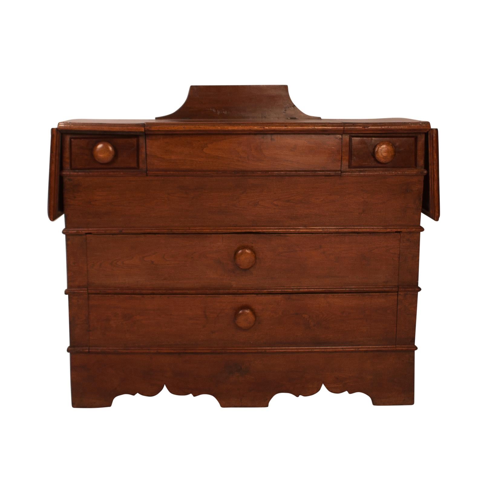 An early Southern Atlantic States black walnut dry sink, circa 1830. There are two drop leaves and two drawers on a tapered body. When opened the piece measures 66
