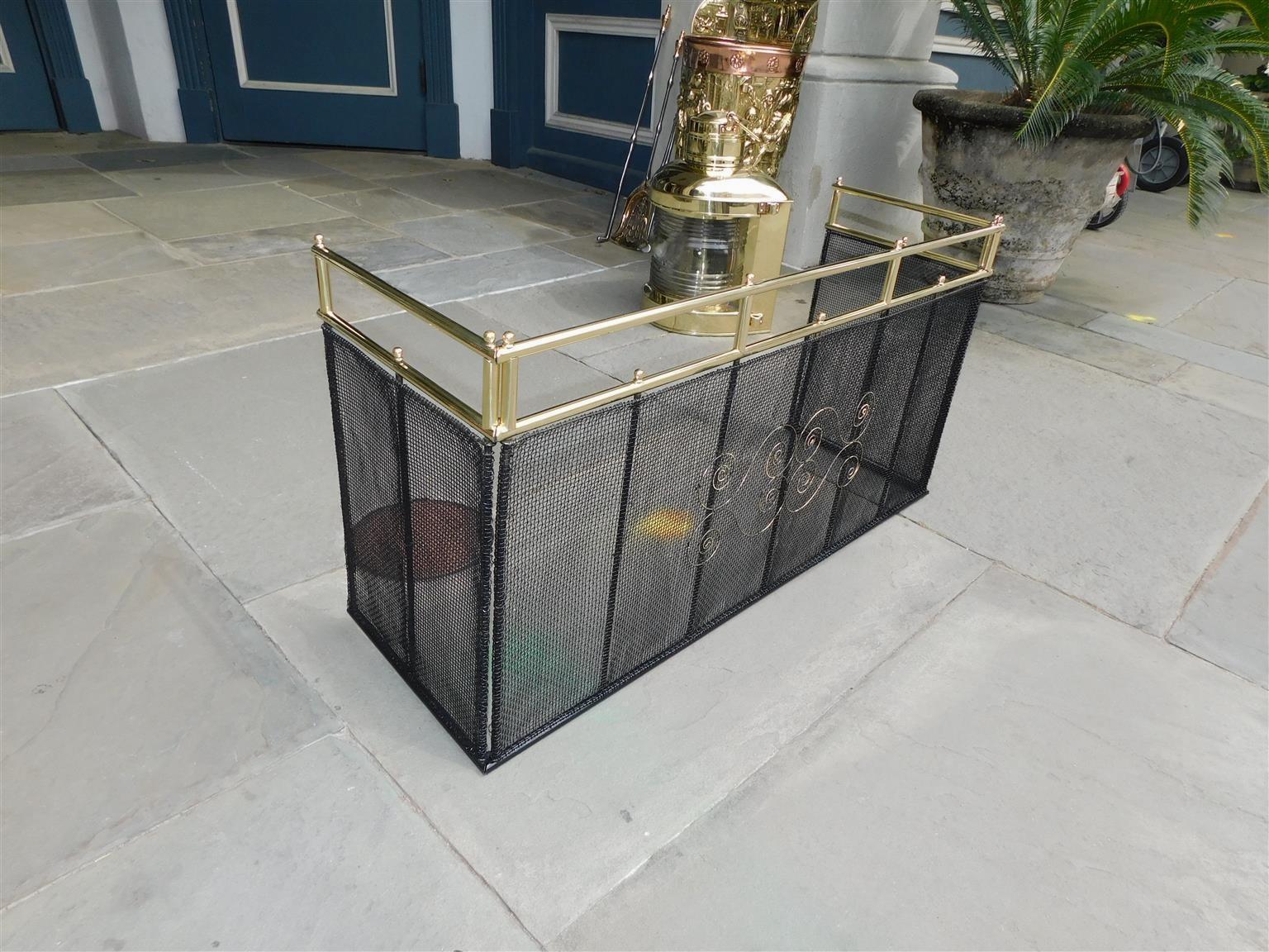 American brass and artistic wire work folding fire place screen with a pleasing brass gallery and flanking ball finials. Early 19th century
Each adjustable folding end on fire screen is 11.75 deep.