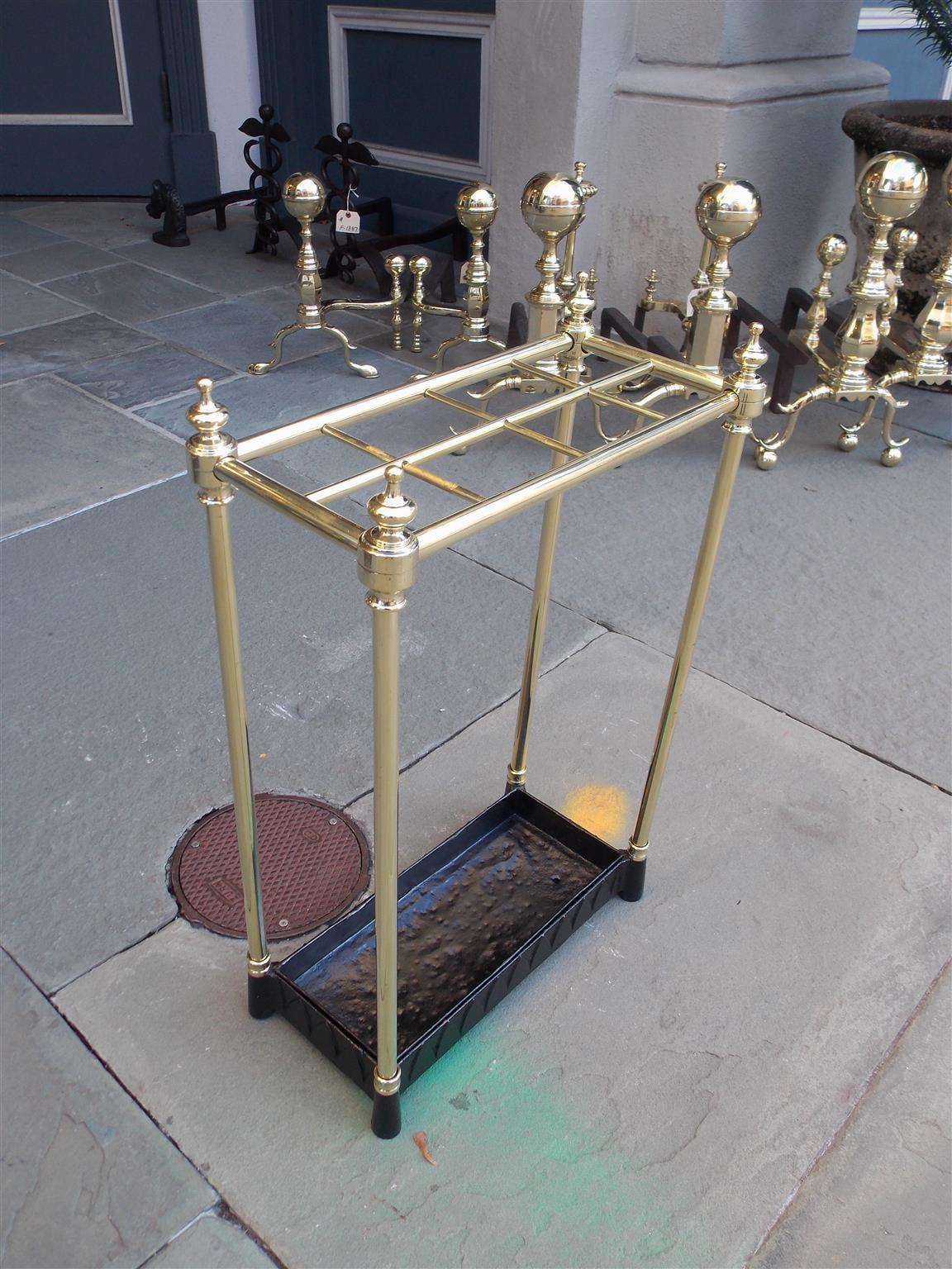American brass and cast iron urn finial pole mounted eight slotted umbrella stand, Late 19th century.