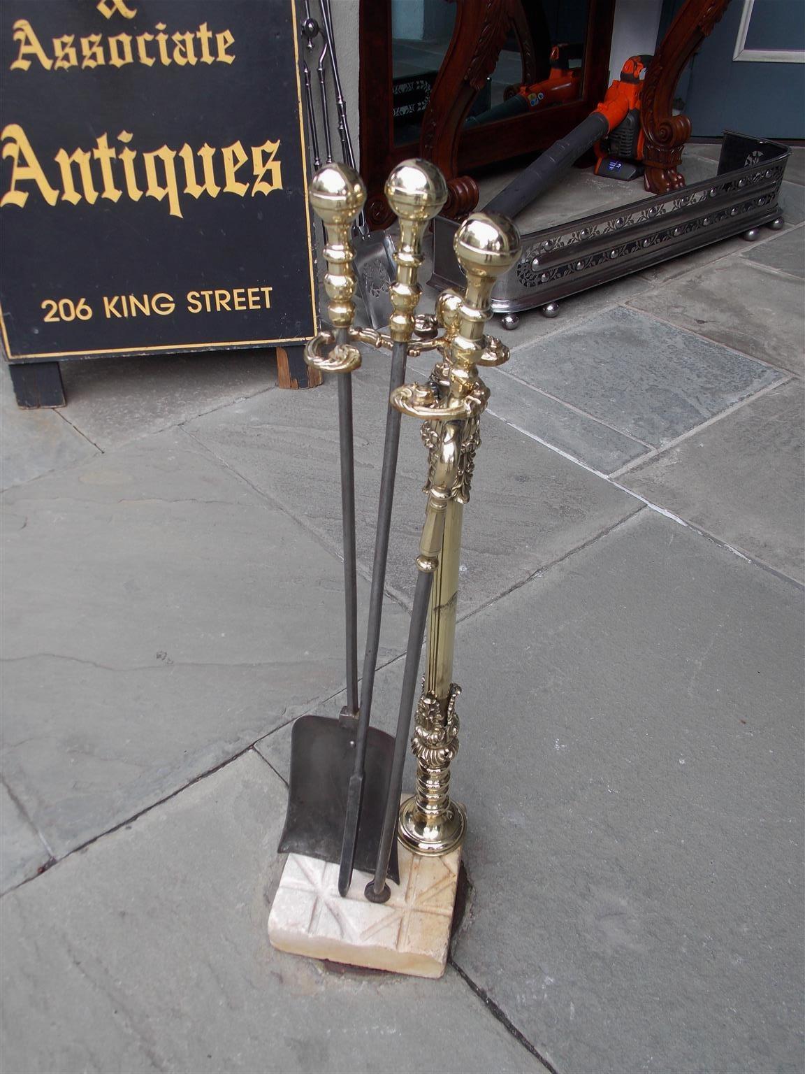 American ball top brass and polished steel fireplace tools on the original scrolled floral cross hatched marble base stand. Set consist of poker, tong, and shovel, Early 19th century.