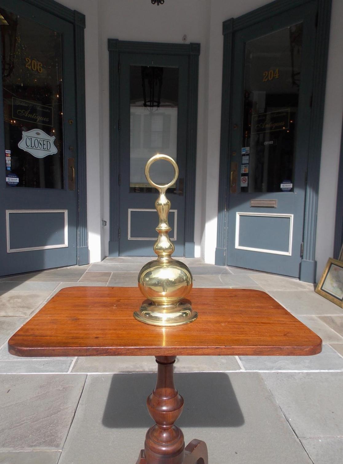 American brass and cast iron bulbous door stop with a centered ring handle, Early 19th century.
