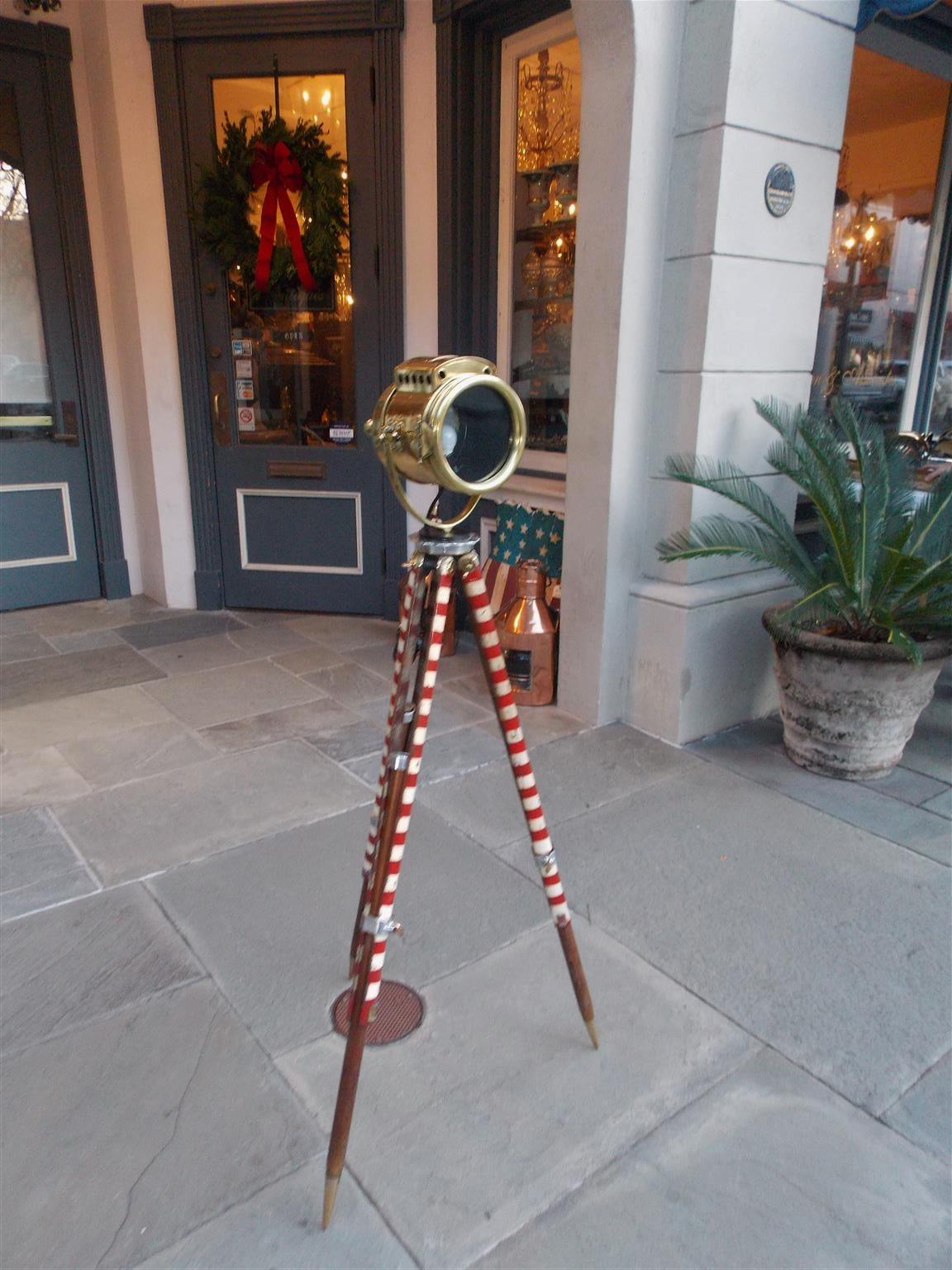 American brass Nautical Swivel spot light on telescopic barber pole tripod stand, Troy, NY. Late 19th century. Original candle and has been electrified.