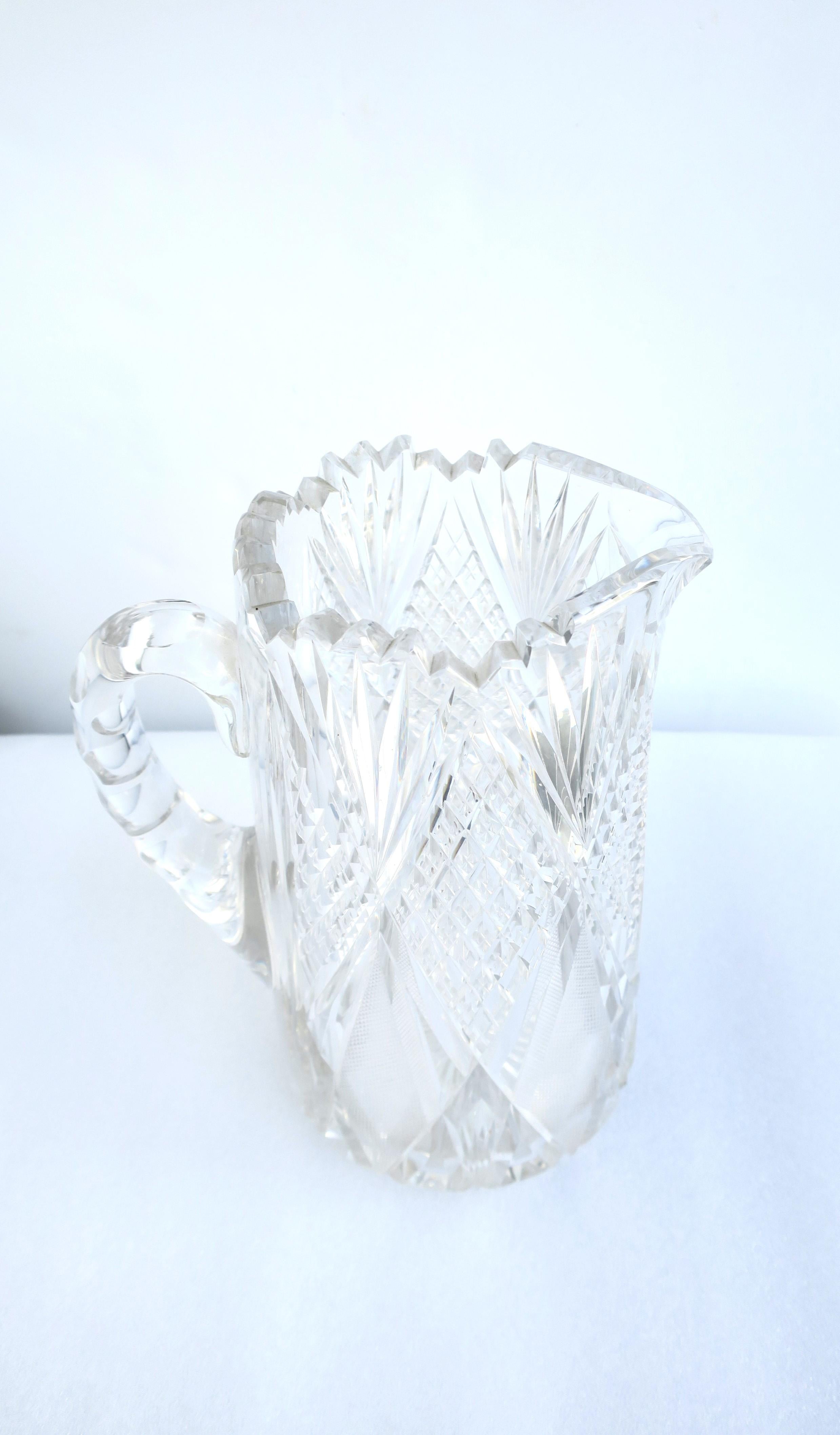 A very beautiful and substantial, American brilliant cut crystal pitcher (or vase), Victorian period, circa early-20th century, 1900s, America. Pitcher has cut detail around exterior, star cut on bottom, and perforated edge around top with smooth