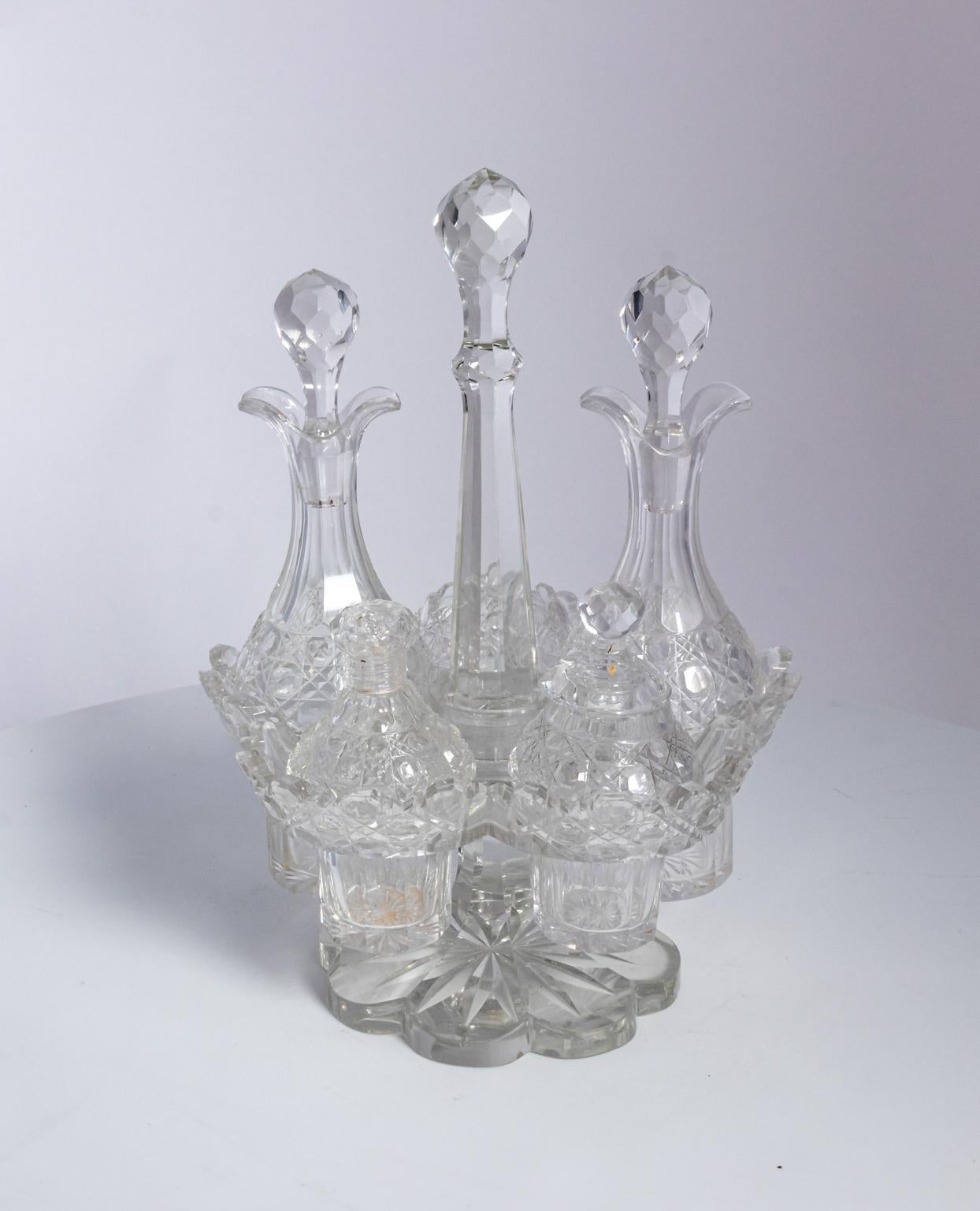 ABP cut glass vintage cruet set, two bottles with stoppers 8.00 inches high, one mustard with cover 4.375 inches high, one salt shaker 4.375 inches high, one pepper dip 2.00 inches high. A minor flake may be found.
