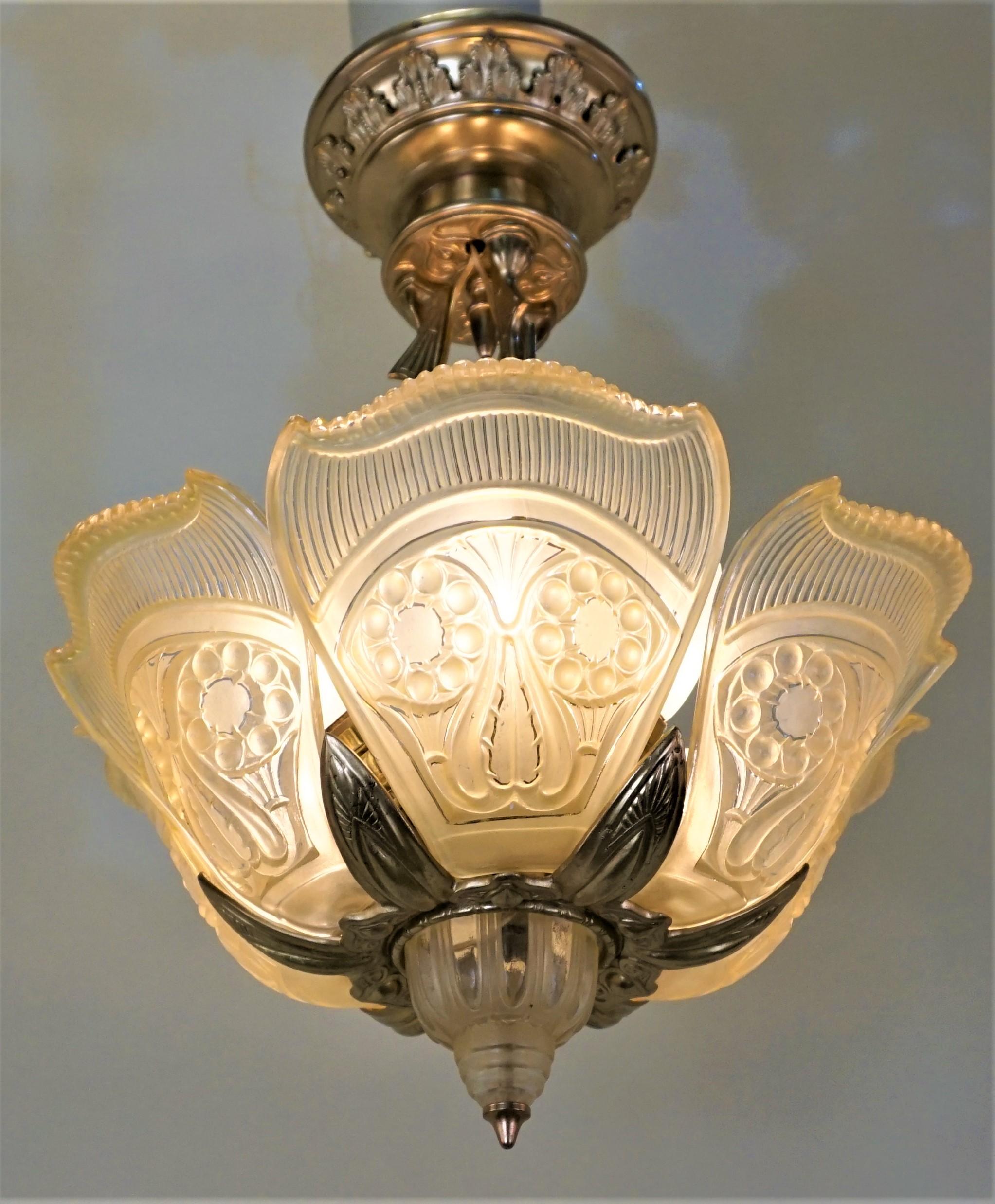 Rare American Art Deco bronze chandelier with amber-clear glass shades.
Six-light- 60 watt each.