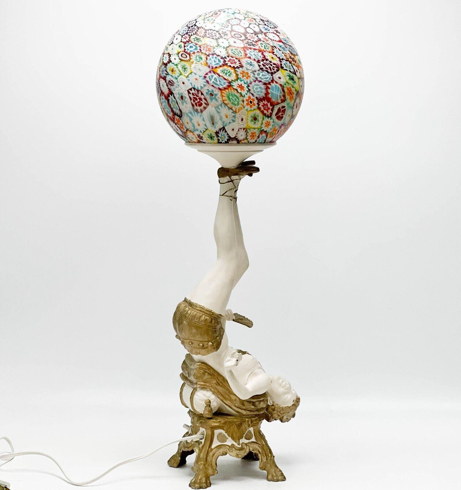 American bronze Murano millifori glass burlesque dancer lamp, 2nd quarter 20th century. The gilt and cold painted bronze or heavy cast metal stem of the lamp depicts a Burlesque dancer upside down holding a hand fan. Murano Millifiori glass globe to