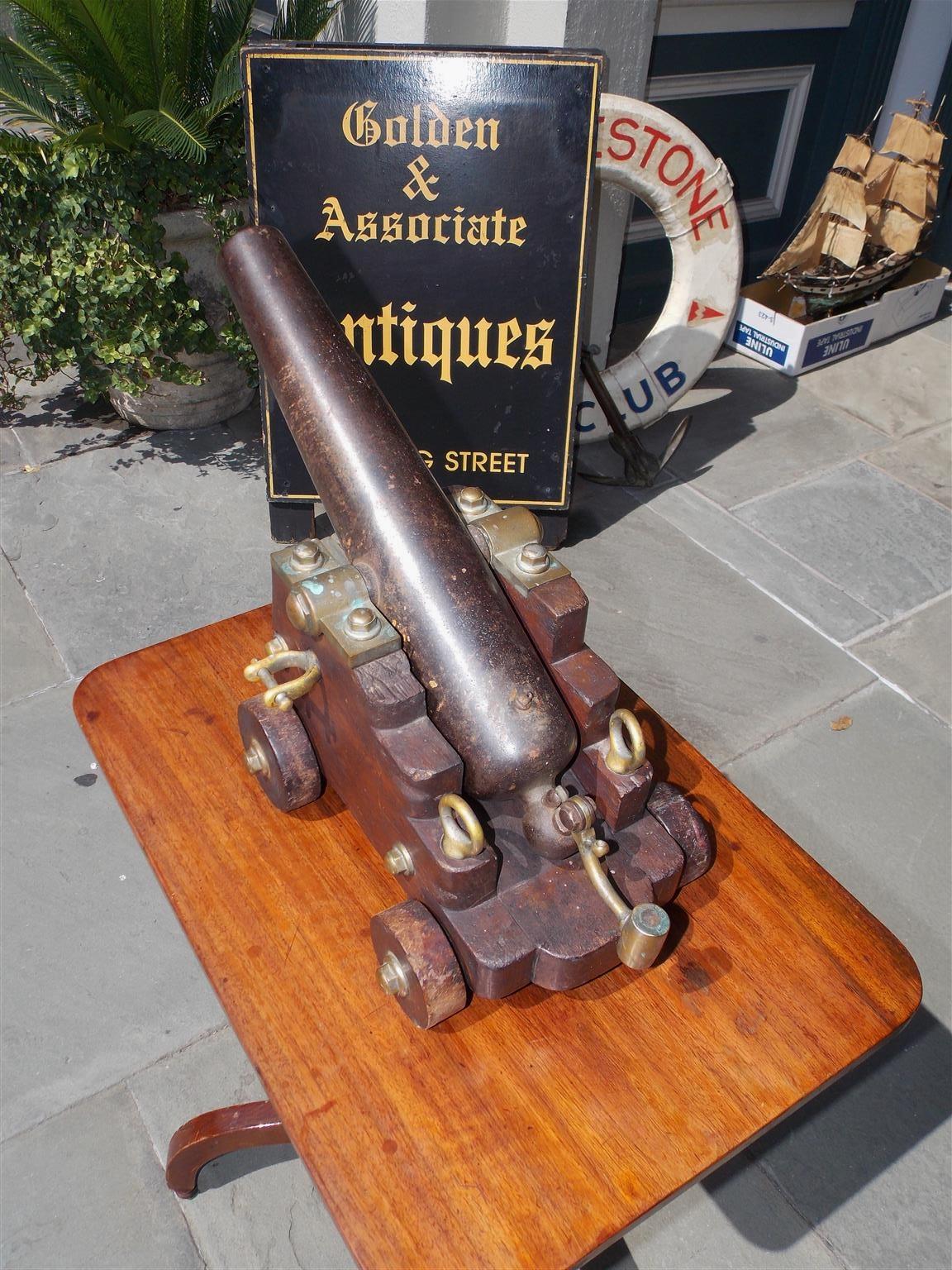 American bronze signal cannon with a steel barrel and resting on the original mahogany carriage with mounted wheels. Late 19th century. Barrel length is 16.5 inches long, Bore is 1 inch, and Fires a .985  lead ball. 