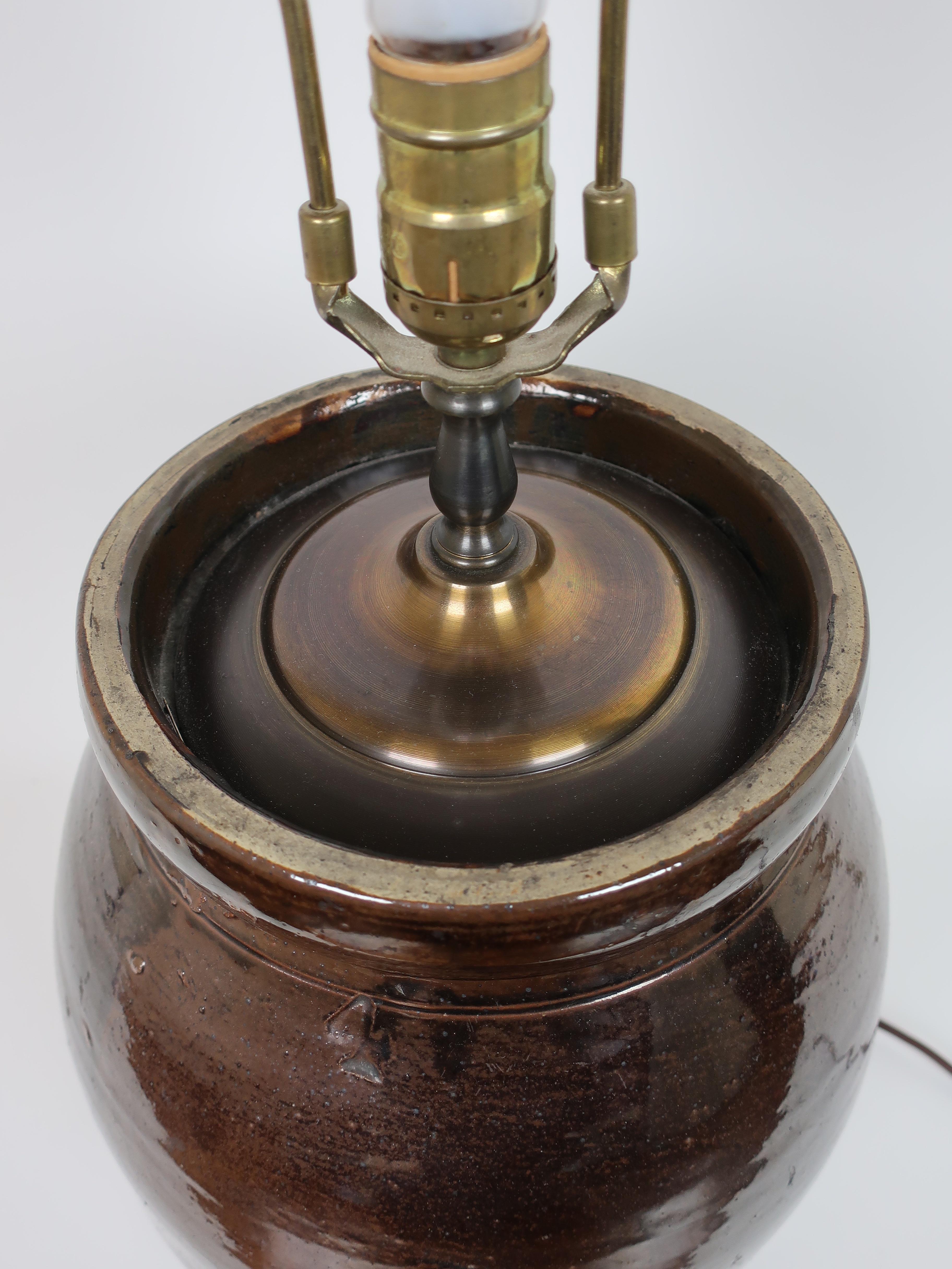 Authentic brown glazed crock that has been converted into a lamp. It has been newly wired and has a 3-way switch. 

Height to top of switch: 21.5.