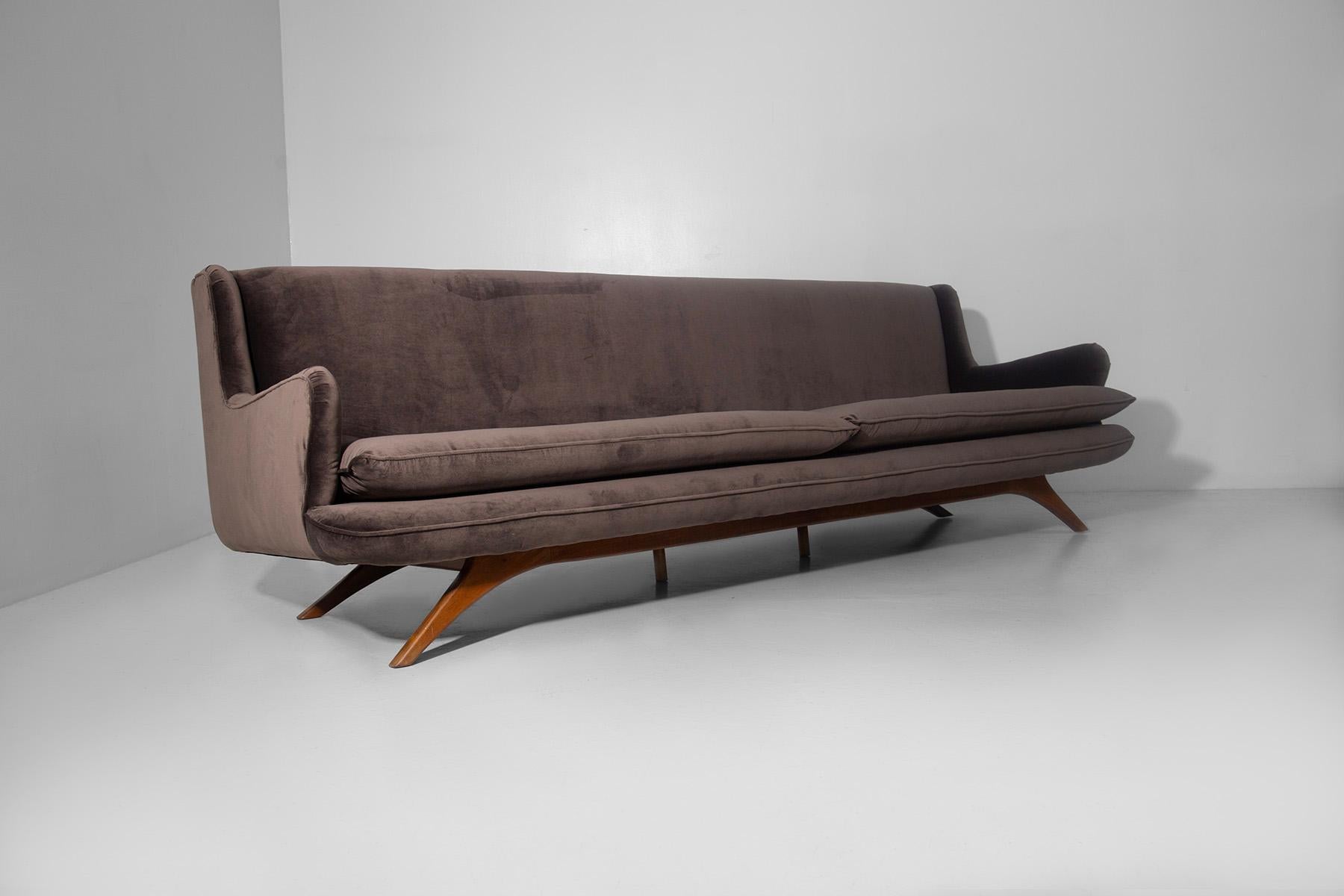 Imposing brown velvet American sofa embodies elegance and comfort in perfect balance. circa 1950s-60s. The recently refreshed velvet envelops the frame with its soft and refined texture, exuding a warm and welcoming charm that invites