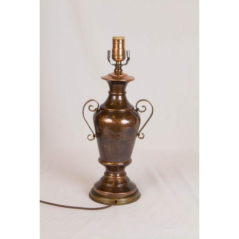 Copper table lamp. Urn Form, with darkened copper finish. Wood base. Completely restored and rewired. C. 1950

Dimensions: 
Height: 17
Width (diameter): 5.5