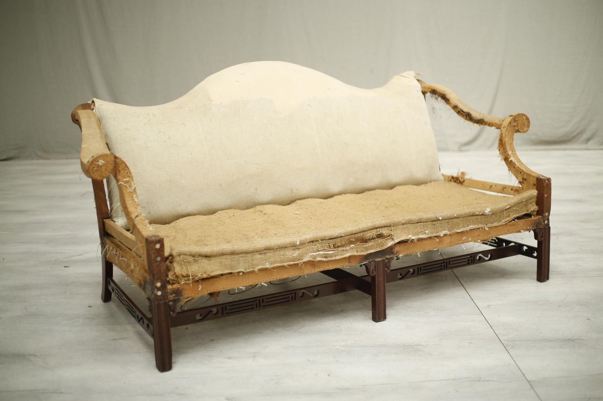 This is an extremely elegant and very well made c.1930's American mahogany camel backed sofa with fret work stretchers. The quality is very high and its a design I have never seen before. The size is ideal for 3 people and we would suggest a single