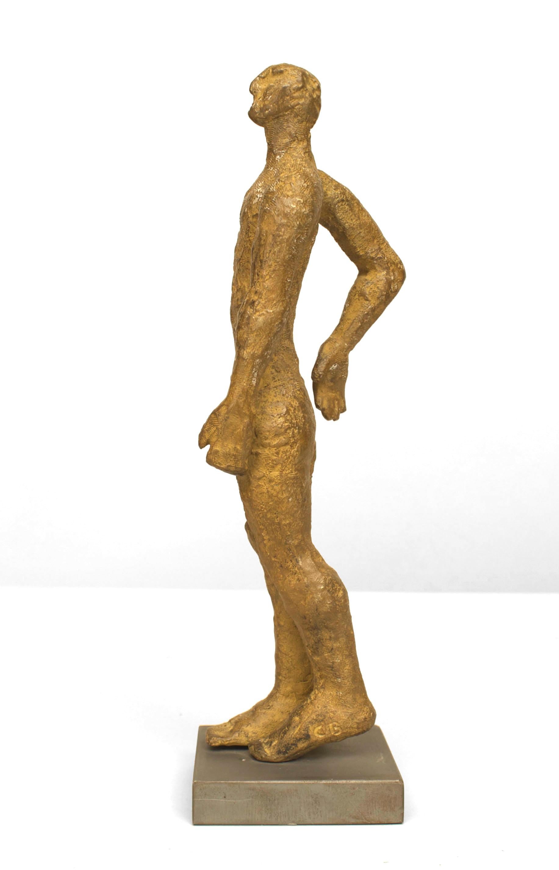 American Post-Modern Design gold patina bronze sculpture of a standing figure with 1 arm bend and the other straight on a square base. (signed: CAROL BRUNS, titled 