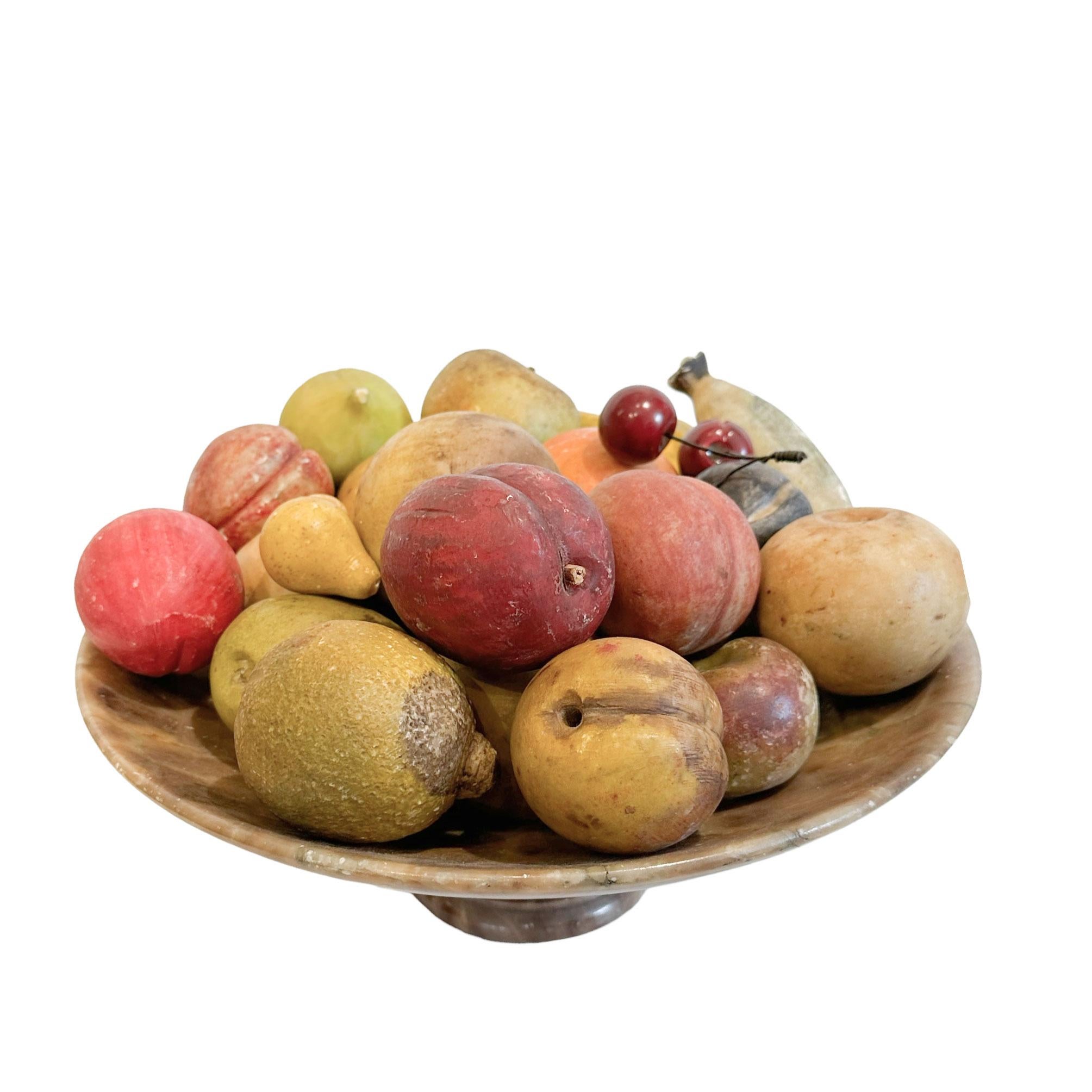 Assortment of American carved and painted stone fruit with marble compote.
Comprising of 23 pieces; one lemon, three intertwined cherries, four pears, one peach, one fig, one orange, two bananas, four small nectarines, seven apples, and one
