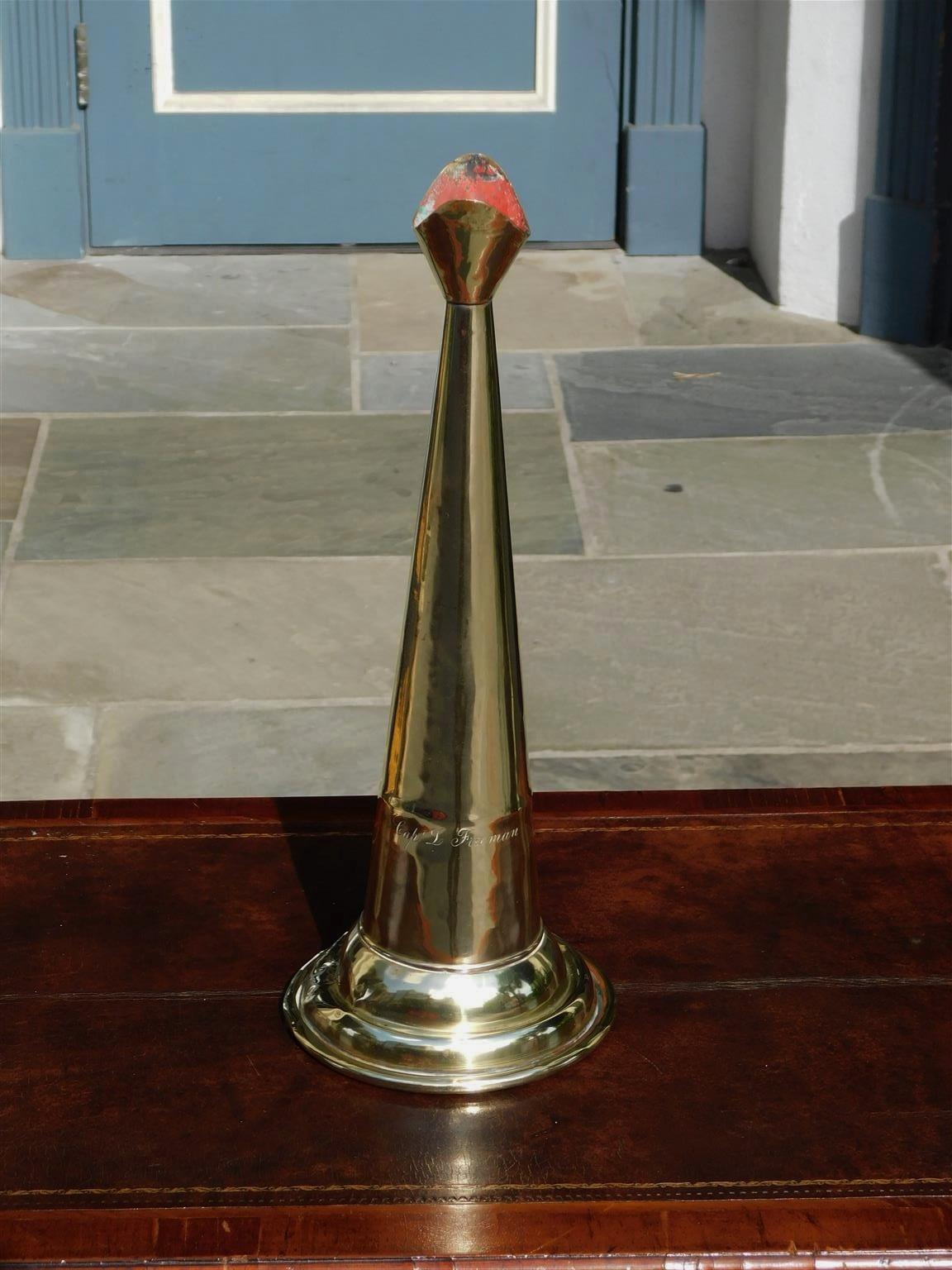 American hand held cast brass engraved Yachtsman's speaking trumpet with bell shaped soldered mouthpiece, coned-shaped column with original interior red paint, and terminating on a rolled molded edge opening, Early-19th century. Trumpet was used to