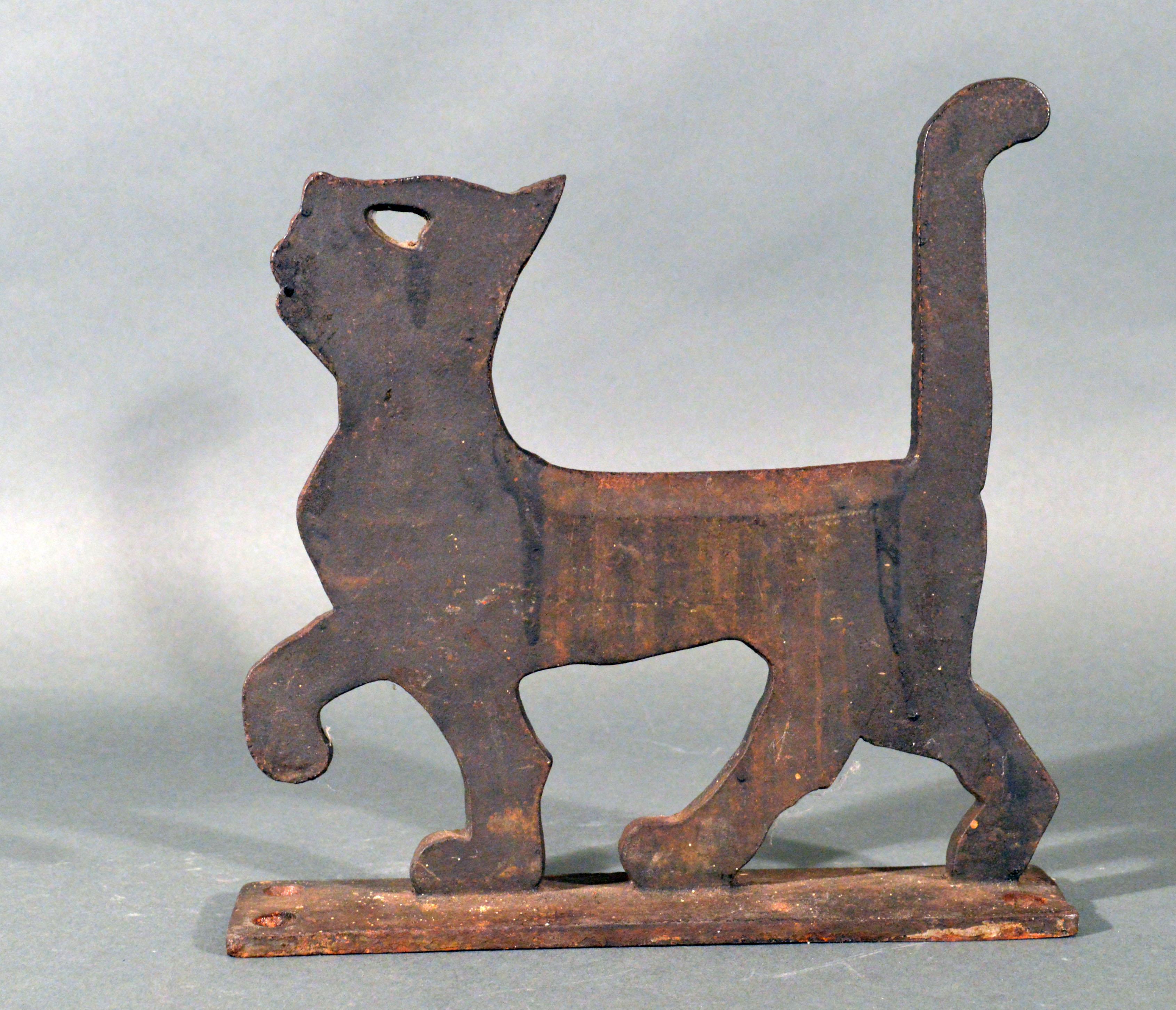 American cast iron boot scraper in the form of a cat,
Household Patent Co. Norristown, PA,
circa 1926
(NY9379-NKR)

The charming Folk Art boot scrapper is in the form of a prancing cat with a pierced heart-shaped eye. The cat with an integrated