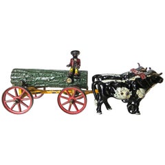 Jouet américain en fonte:: bûche tirée par un bœuf sur un chariot avec cavalier par Hubley