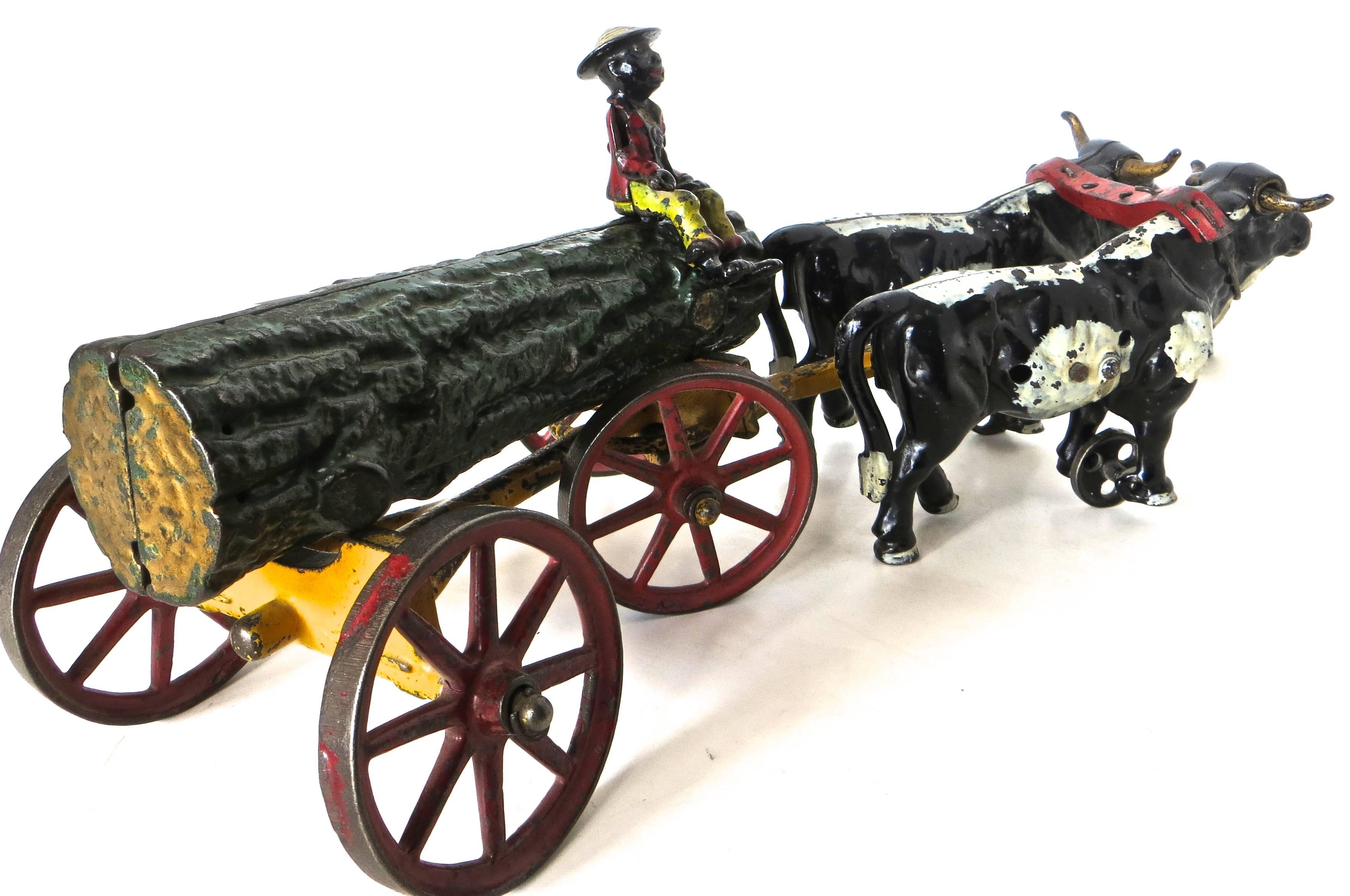 Jouet américain en fonte:: bûche tirée par un bœuf sur un chariot avec cavalier par Hubley 1