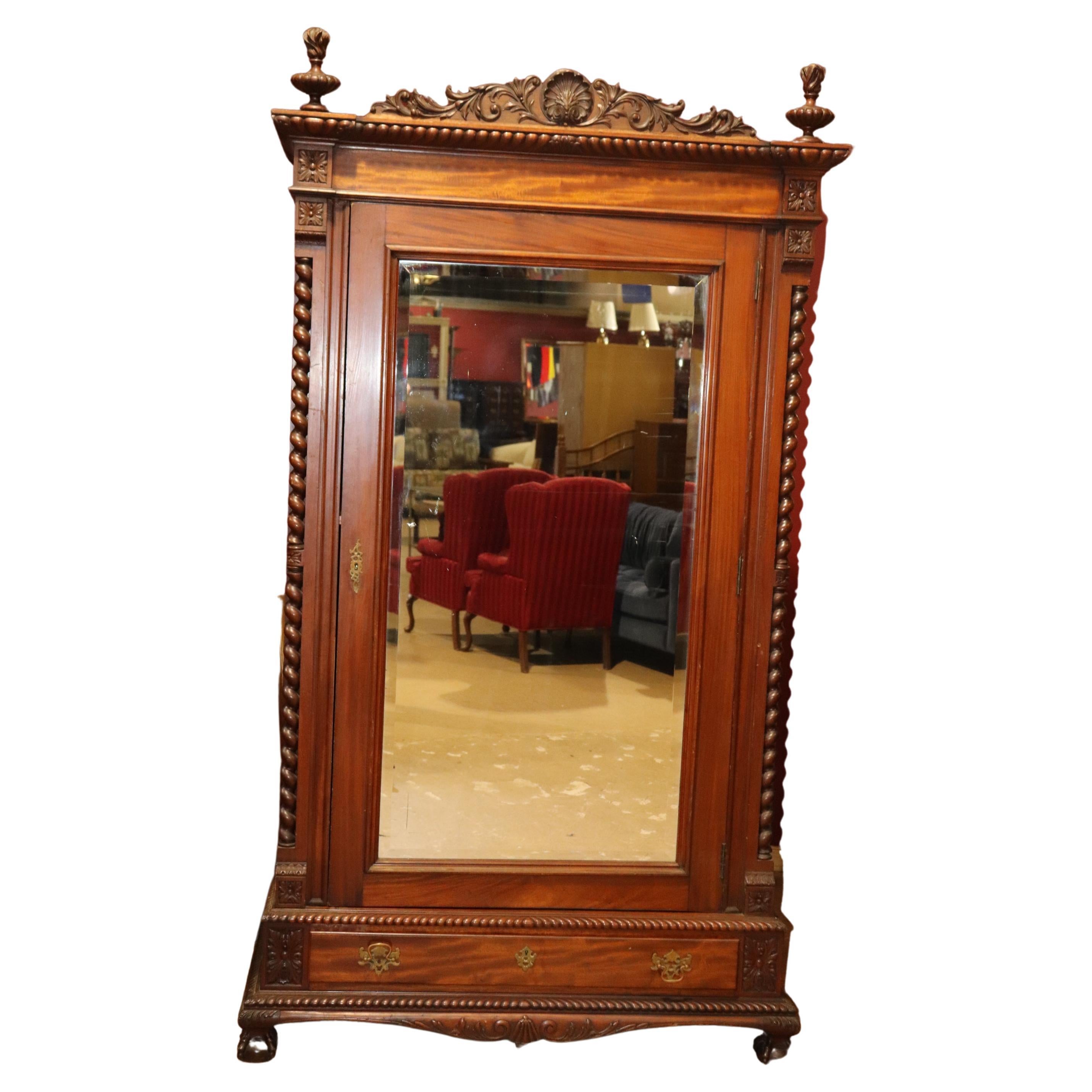 This is a superb carved mahogany Centennial era 1870s Chippendale armoire. The armoire is made during the 1870s era in Philadelphia and made to look like an earlier 1770s era armoire. The armoire measures 24 deep x 55 wide x 97 tall.