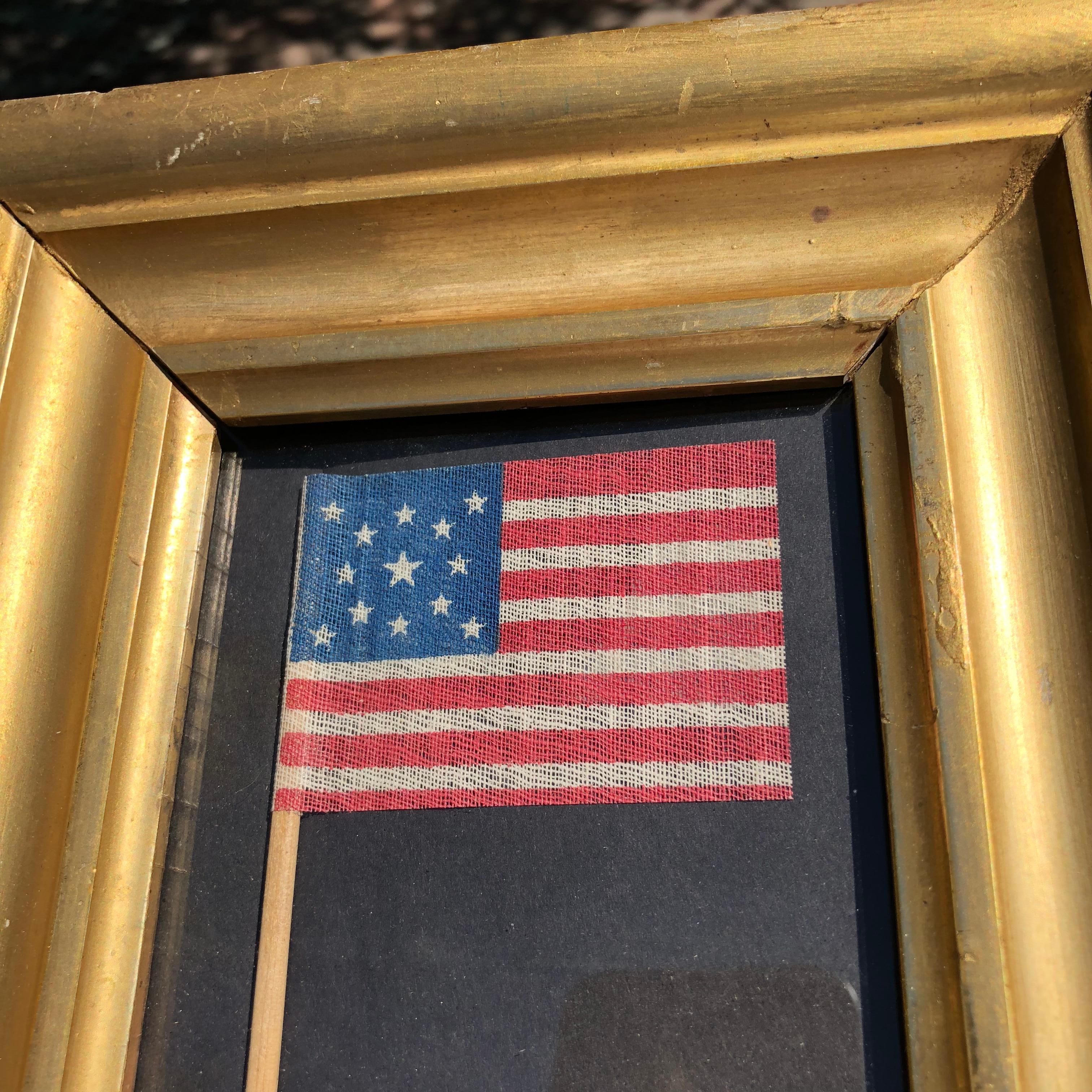 Mounted in a gold frame, printed on cloth these flags were used in 1876 to celebrate the centennial.