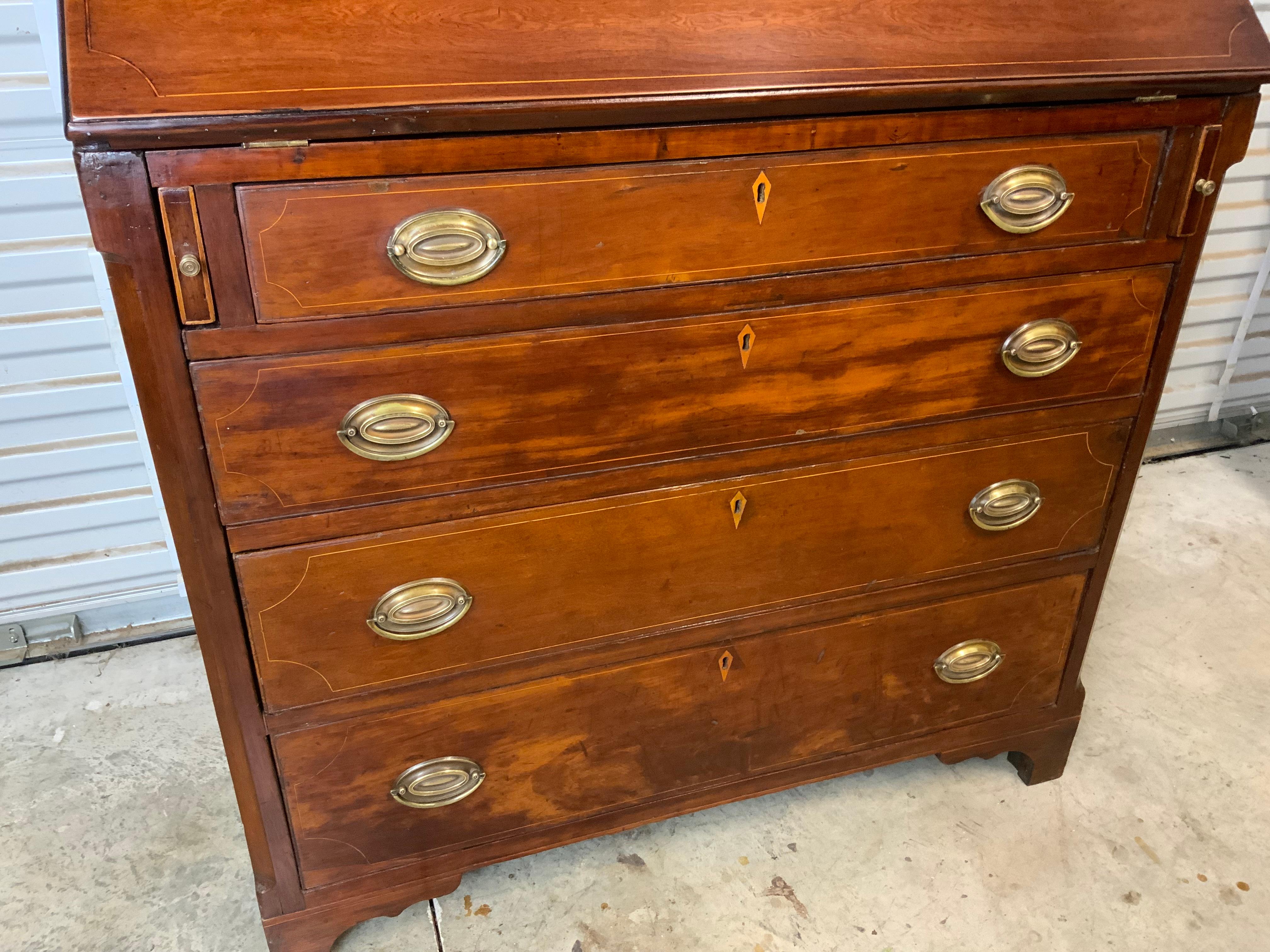 Very nice early 19th century southern Cherry inlay slant front desk probably Tennessee or Kentucky 1820-30. String inlay on the lid and drawer fronts, inlay banding around the bottom of the case, and canted case corners. Yellow pine secondary wood. 