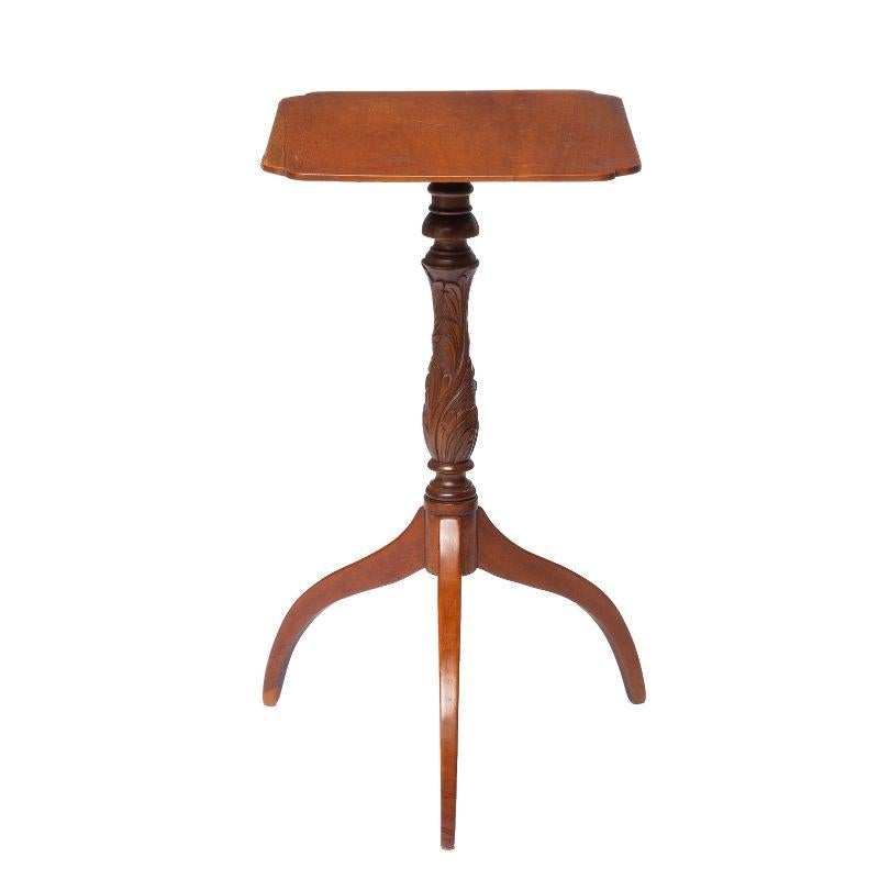 Cherry spider leg candle stand with exceptional feather carved baluster pedestal supporting a square chamfered single board table top, with scollop cut corners.

American, Connecticut Valley, circa 1800.