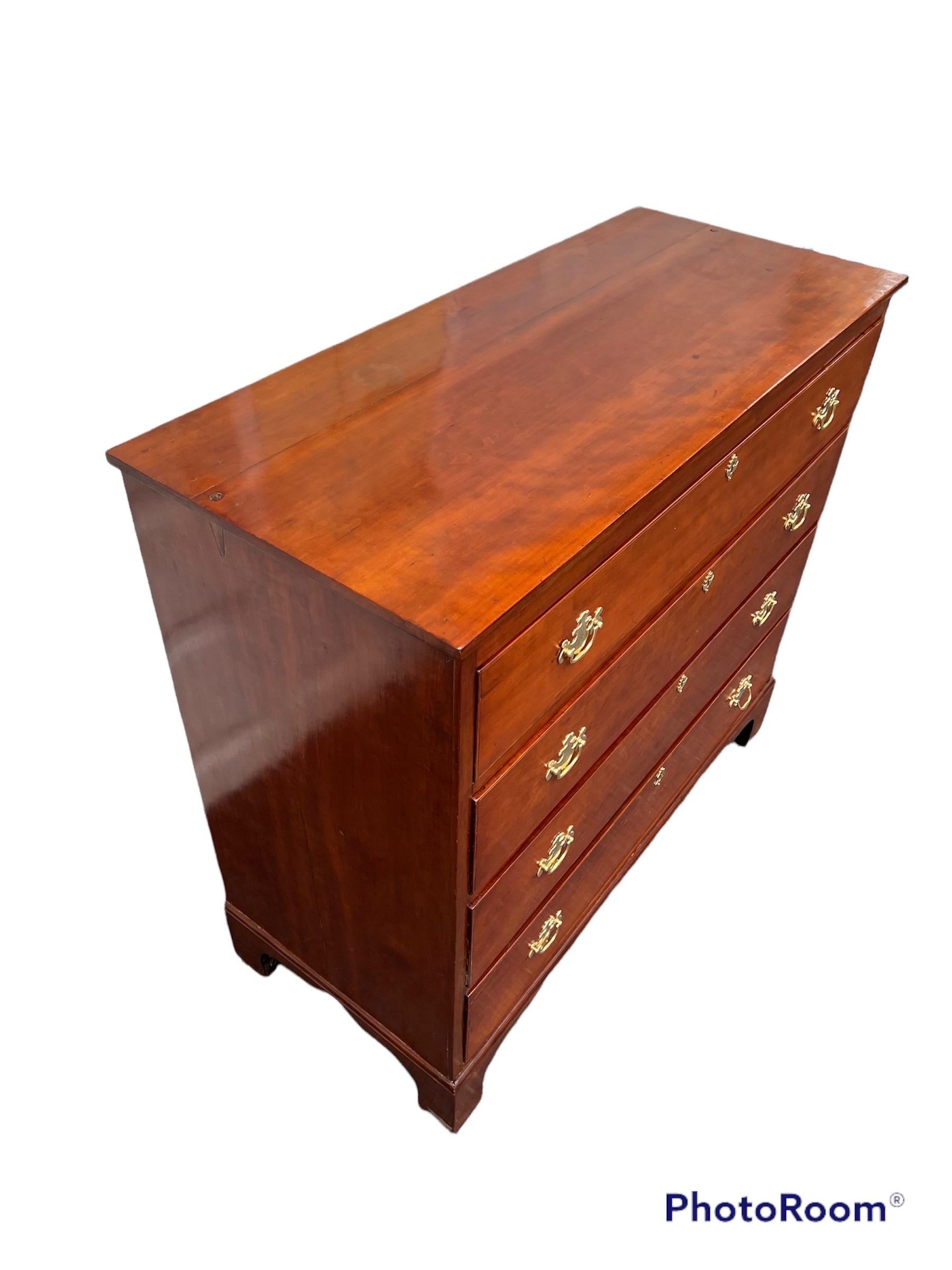 American cherry wood chest of drawers with graduated drawers,
brass handles & keyhole escutcheons.
 