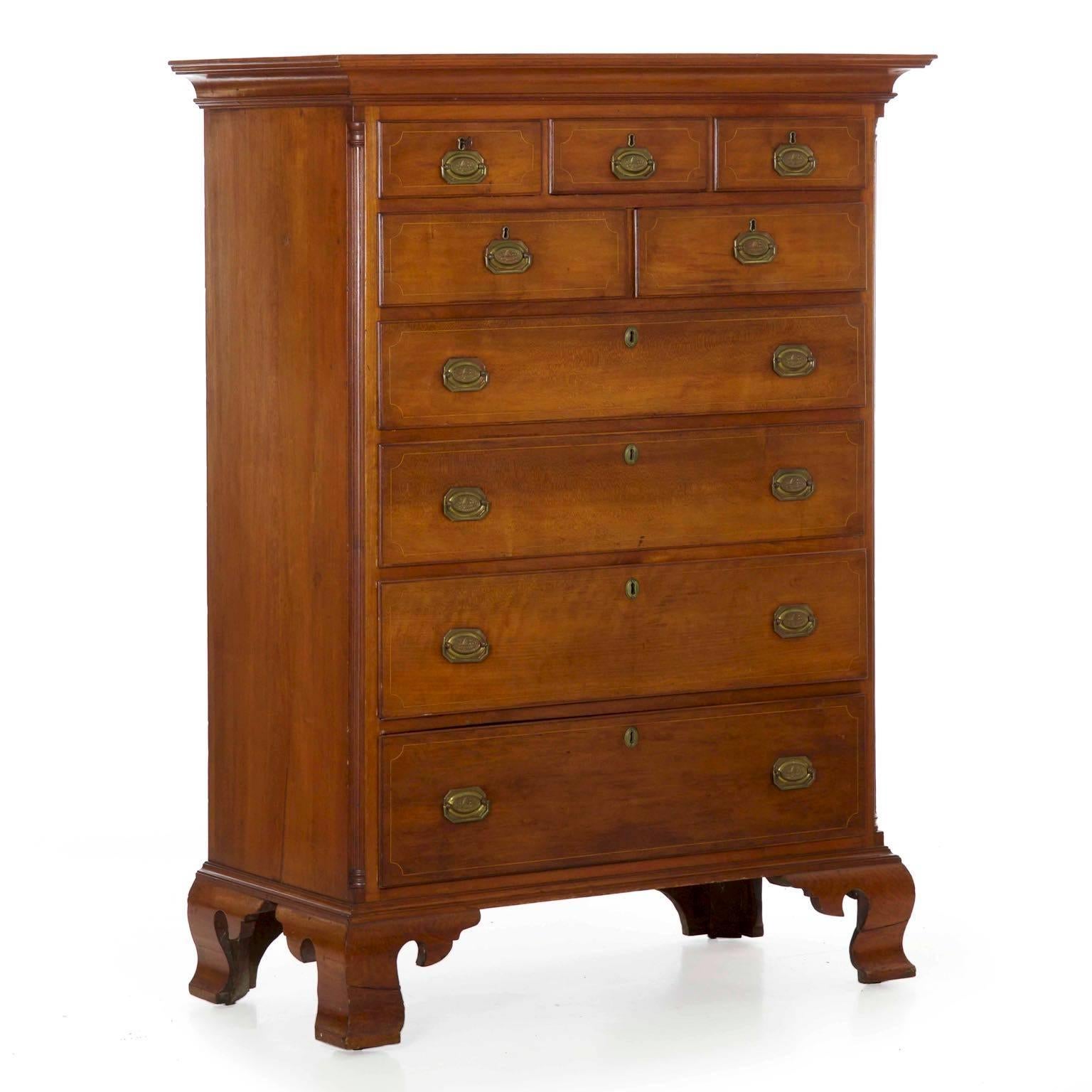 Remaining in excellent original condition, this fine tall chest of drawers shows the transition of styles from the earlier Chippendale tradition into the more edgy and refined Federal style. Notable first in the Hollywood stringer inlays with the