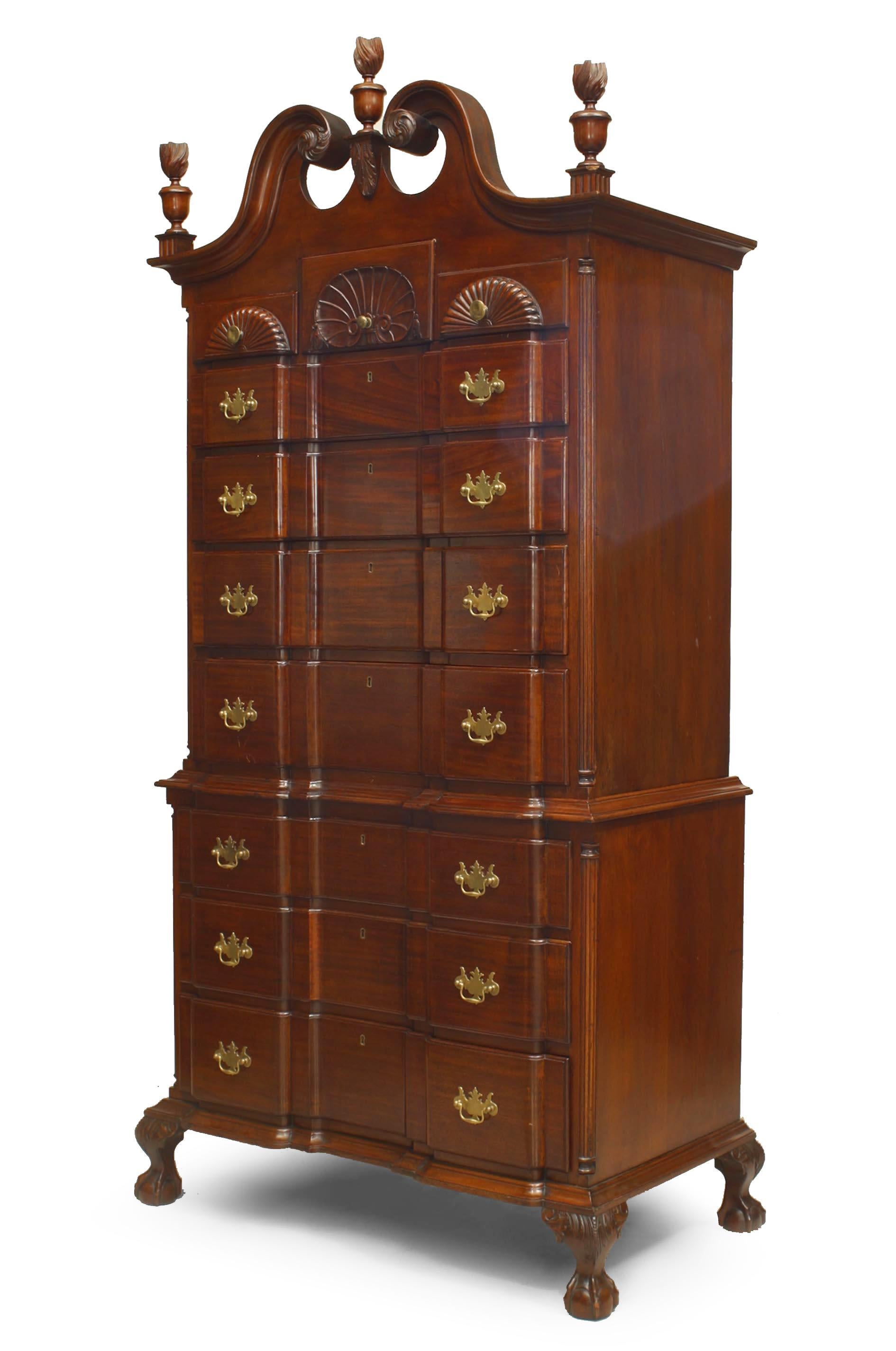 American Chippendale style mahogany chest on chest cabinet with 7 drawers below 3 shell carved small drawers with flame form finials and broken pediment top (Early 20th century).