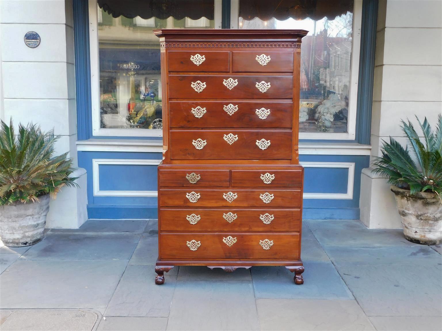 American New York Chippendale mahogany chest on chest with a carved dentil molded edge cornice, articulated carved circular fret work, ten graduated drawers with the original period brasses, interior drawer locks, flanking fluted chamfered corners,