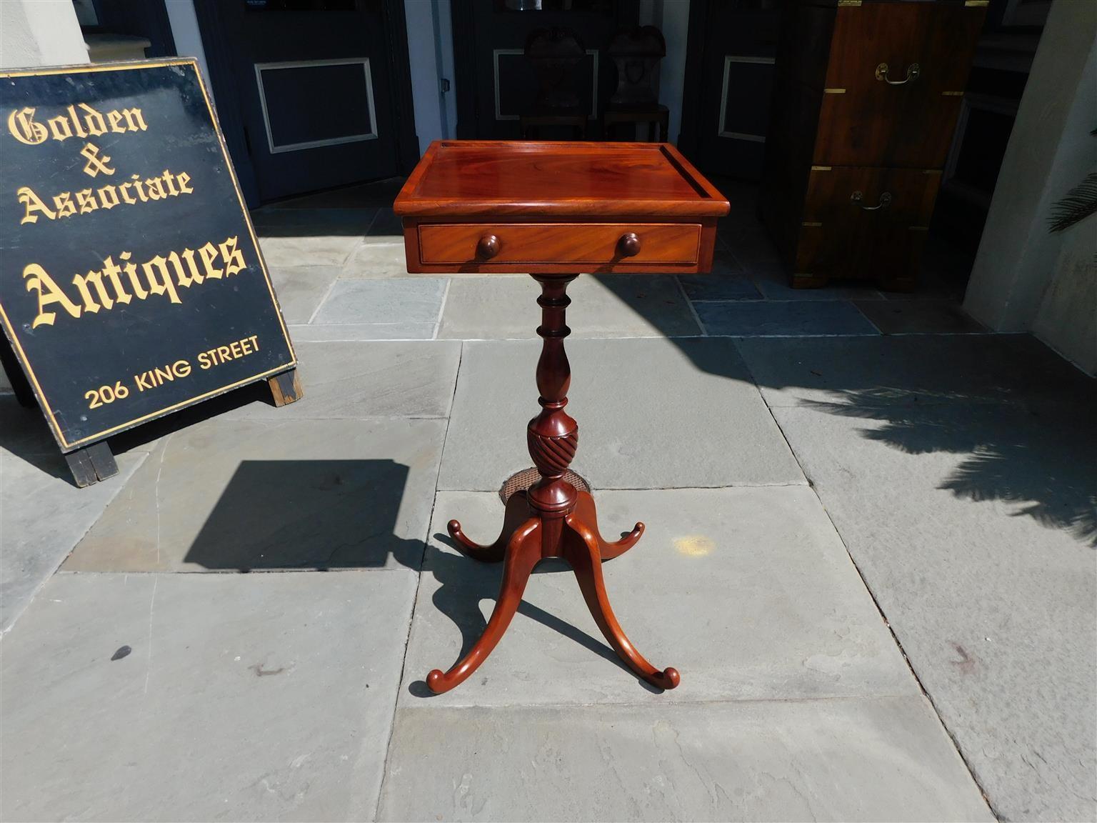 American Chippendale mahogany one drawer side table with a carved molded edge top, original wooden knobs, three faux drawers supported by a turned bulbous spiral urn pedestal, and resting on splayed legs with sweeping feet. Late 18th century.
  