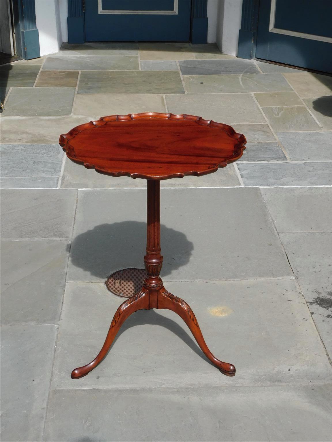 American chippendale mahogany pie crust tilt top kettle stand with fluted urn center column, original brass banjo locking mechanism, and resting on carved acanthus legs with slipper feet, Mid 18th century