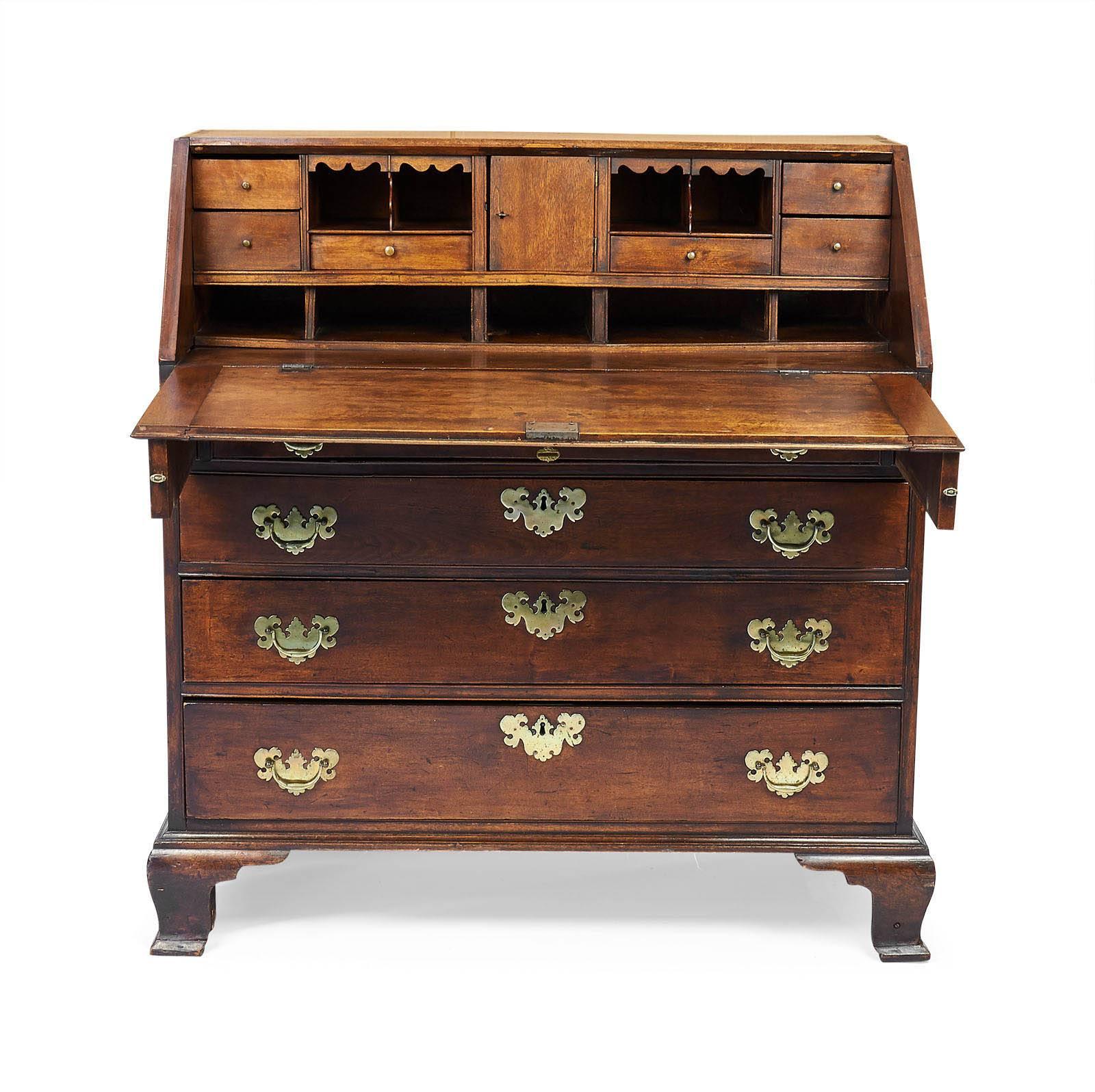 A nice old American Chippendale slant front desk made in New England during the last quarter of the 18th century.  With graduated drawers, what appears to be original finish and well shaped ogee bracket feet.  The brasses are not original but the