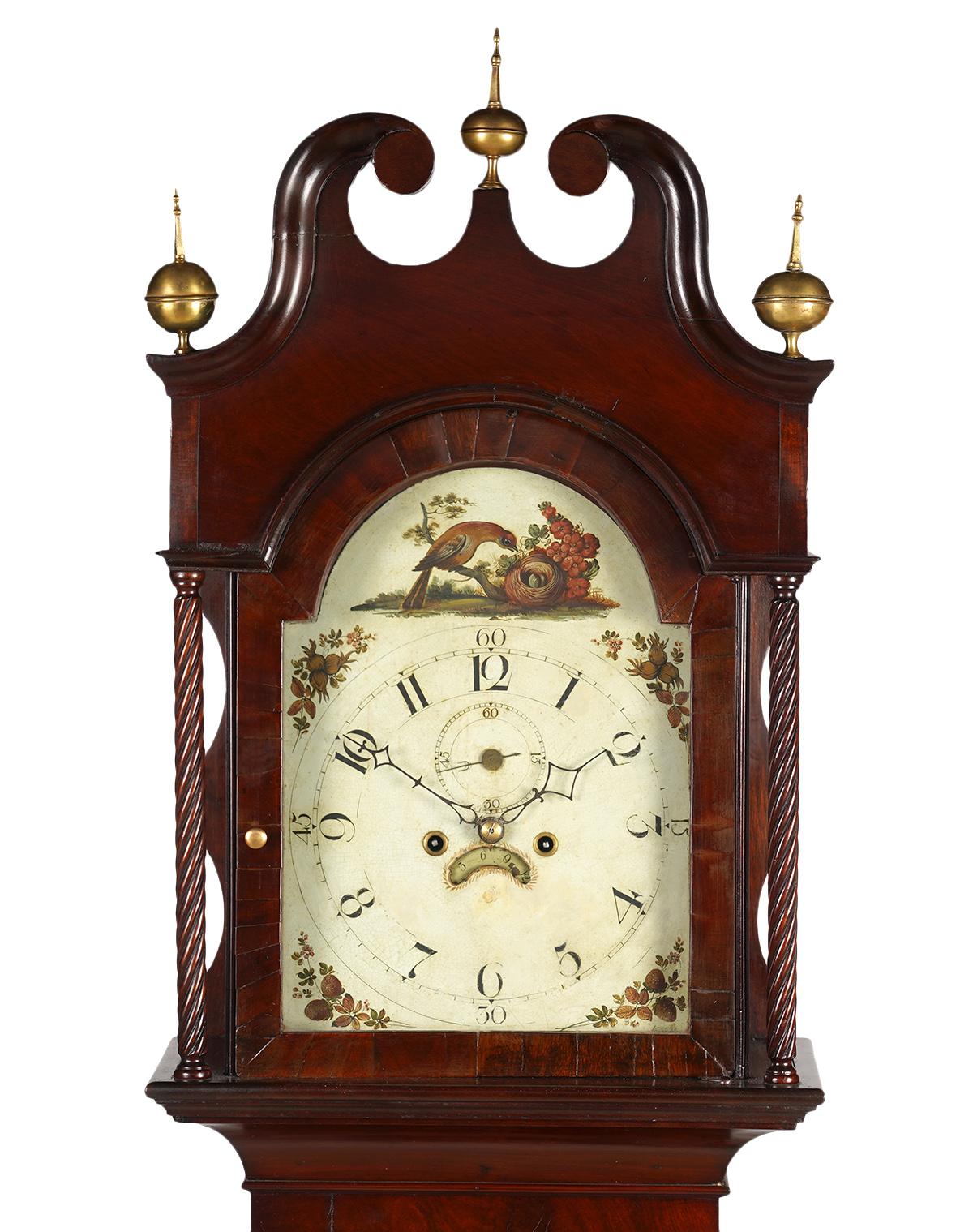 This stately American Chippendale tall case grandfathers 8 day mahogany clock features a double scroll split pediment cresting centering a brass globe finial and flanked by identical finials. The painted dial is decorated with bird nest motif and