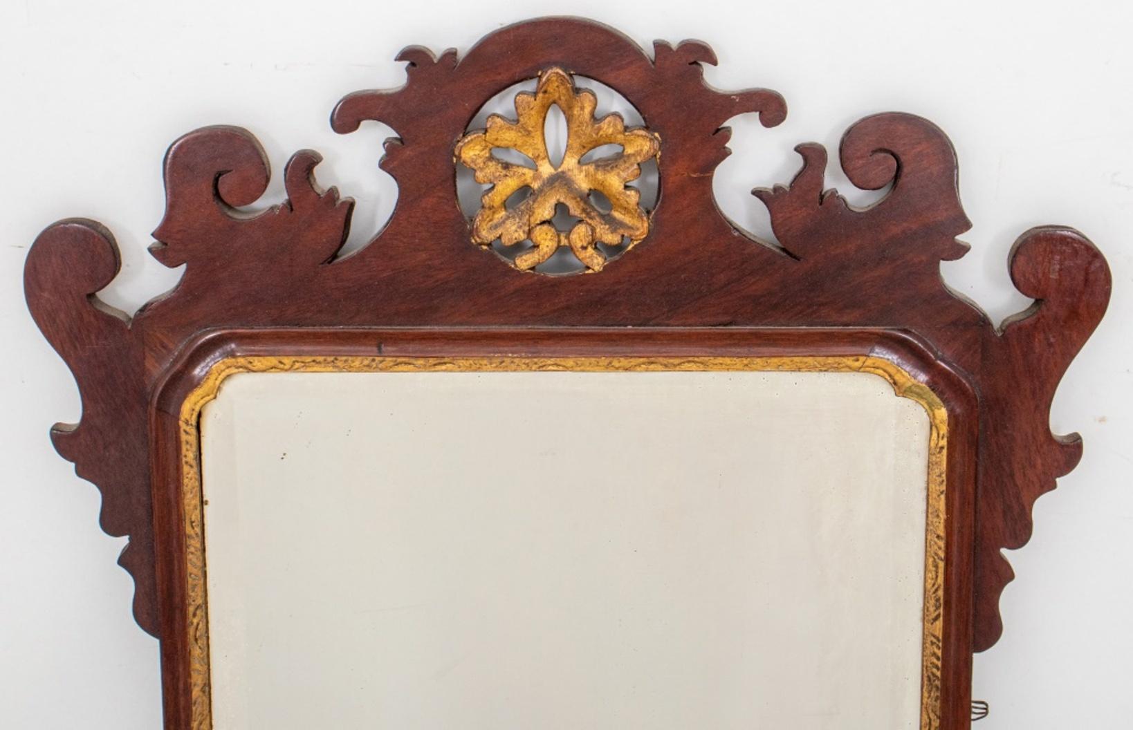 American Chippendale style mirror, parcel gilt and mahogany, centering a rectangular beveled mirror plate.

Dimensions of Mirror: 24