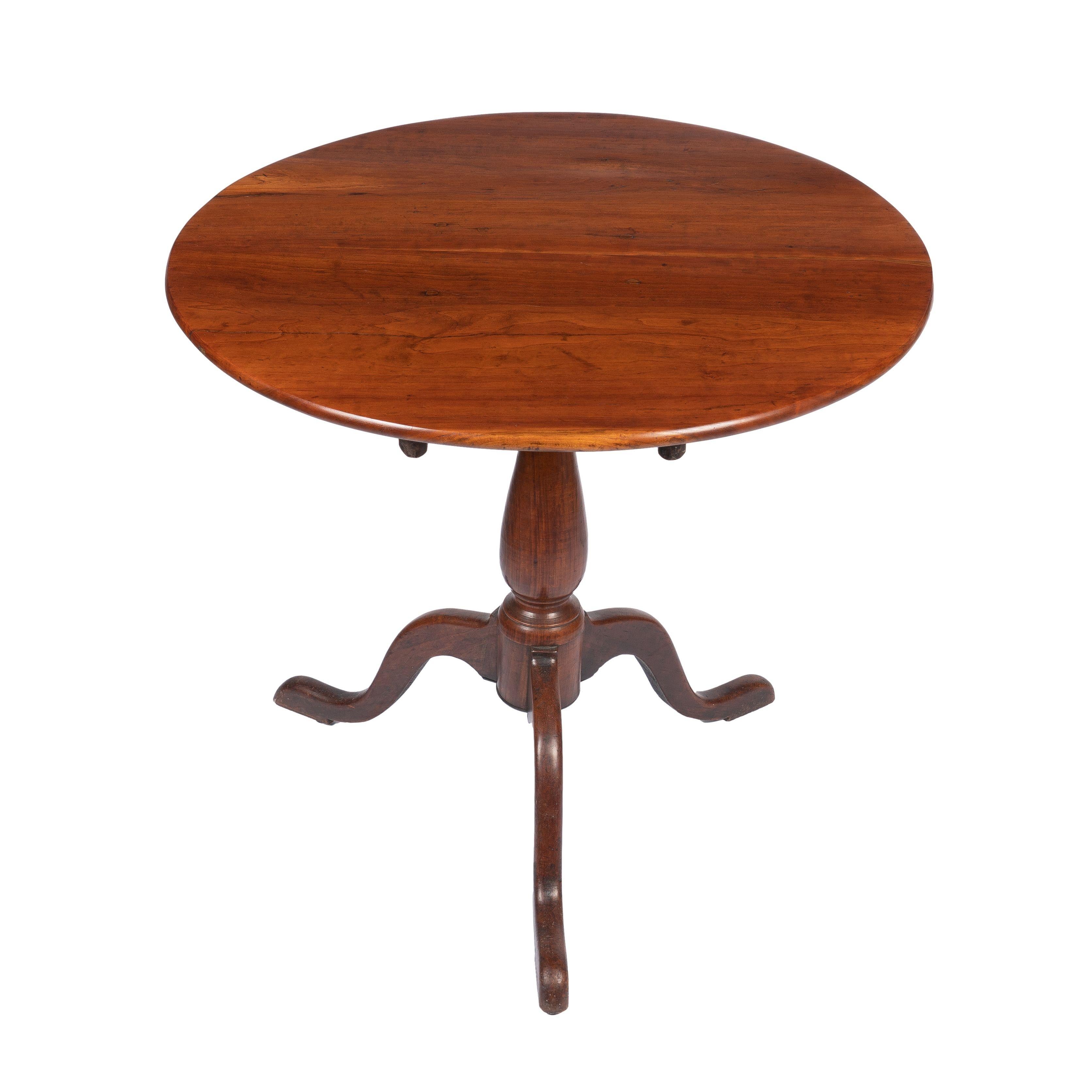 American Chippendale tilt top tea table with a two board cherry wood top. The top rests on a baluster turned pedestal which is supported by arched tripod legs on pad feet.
 
American, Upper Connecticut Valley, 1775-1800.