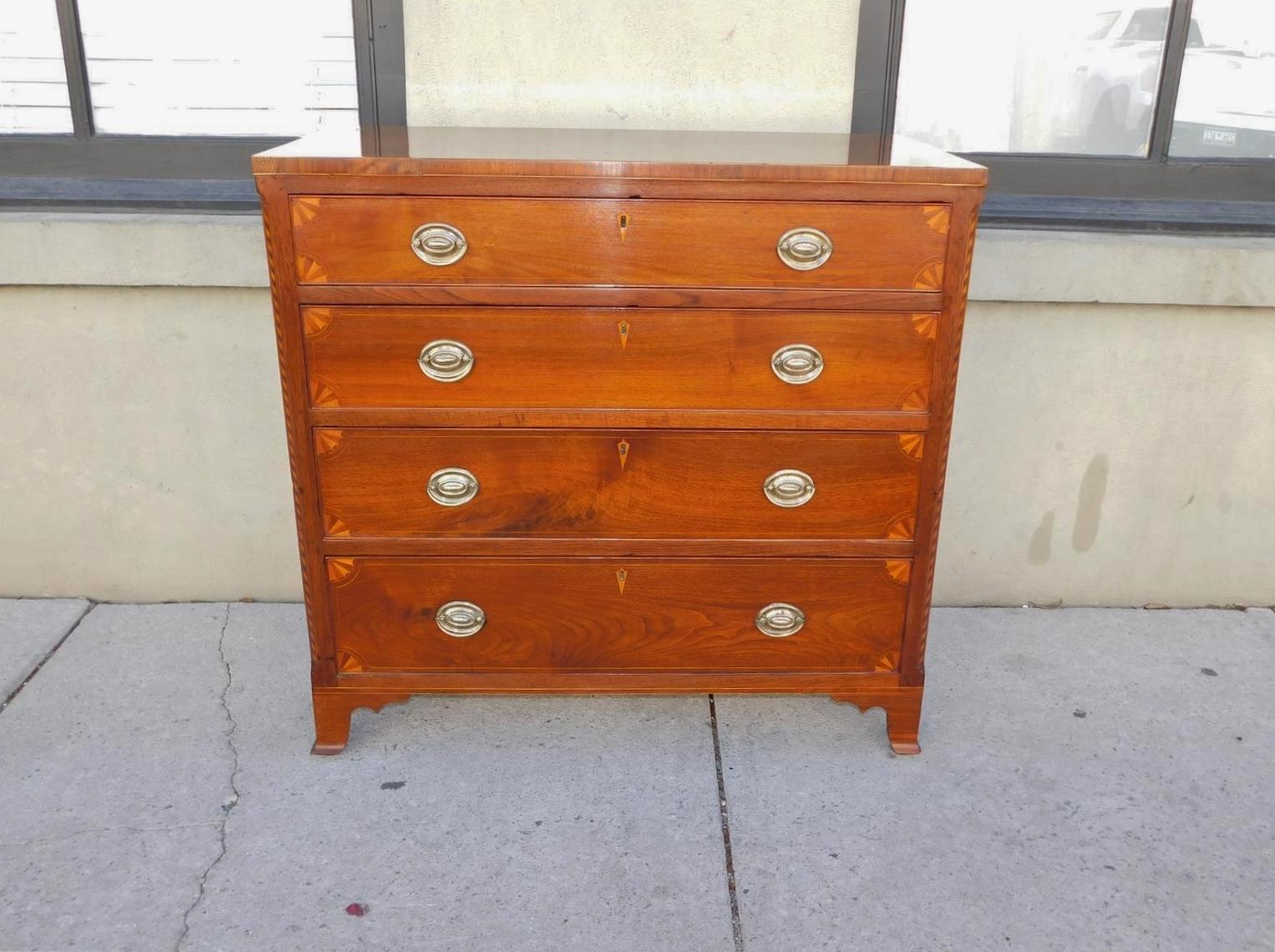 American Chippendale graduated walnut chest of drawers with flanking chamfered corner checkered inlays, drawer front corner fan inlays, central diamond inlaid escutcheons, original oval brasses, and resting on the original bracket feet, Tennessee.