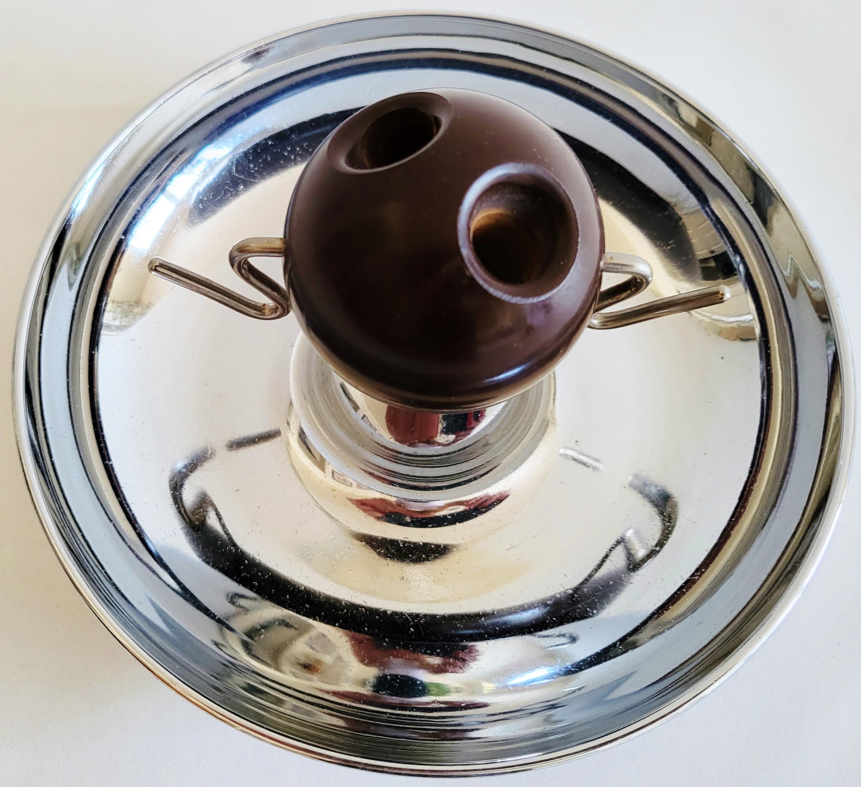 This unusual American circular ashtray is chrome plated and in the center sports a large dark brown 2