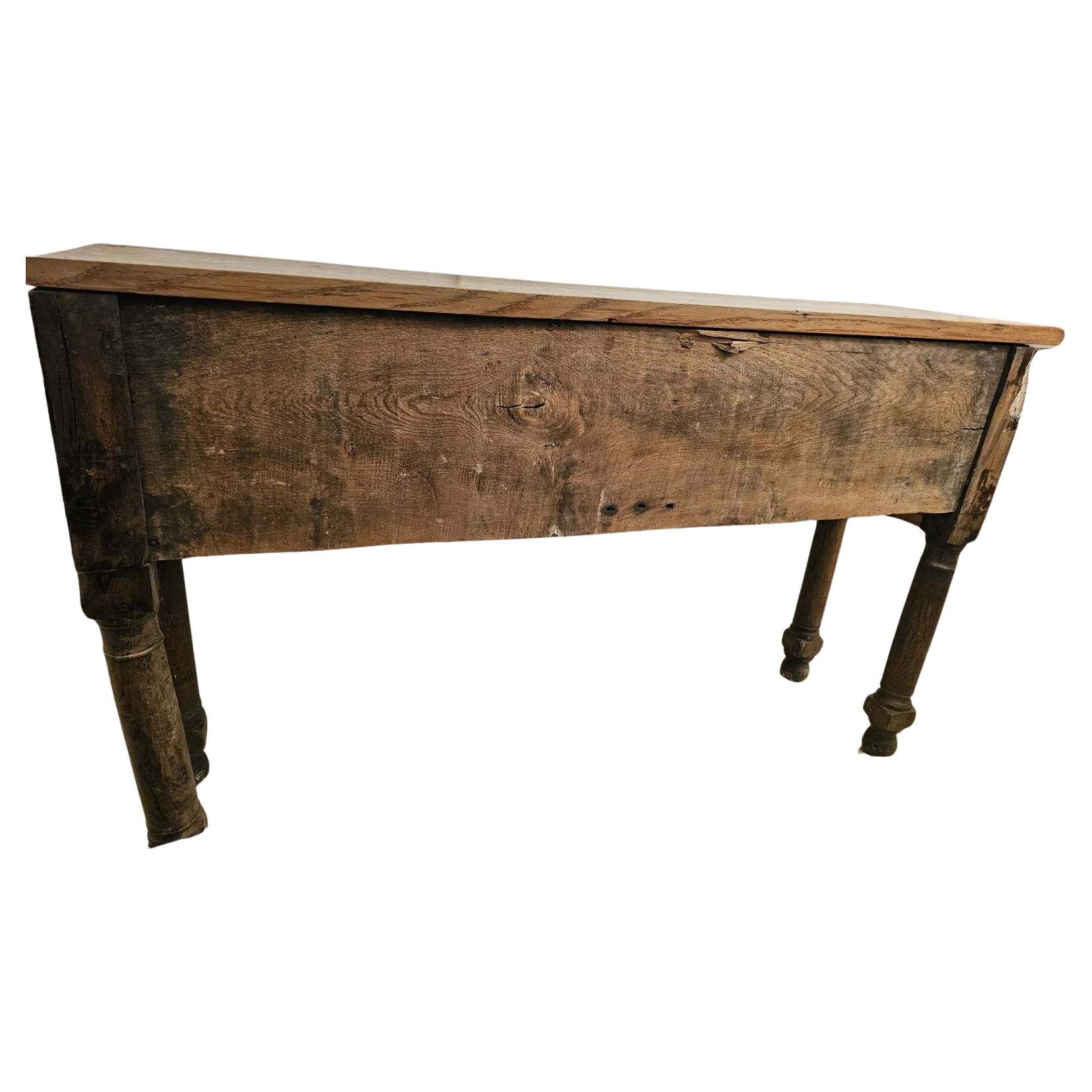 Character rich chunky oak antique console.  Two deep drawers with original iron handles.