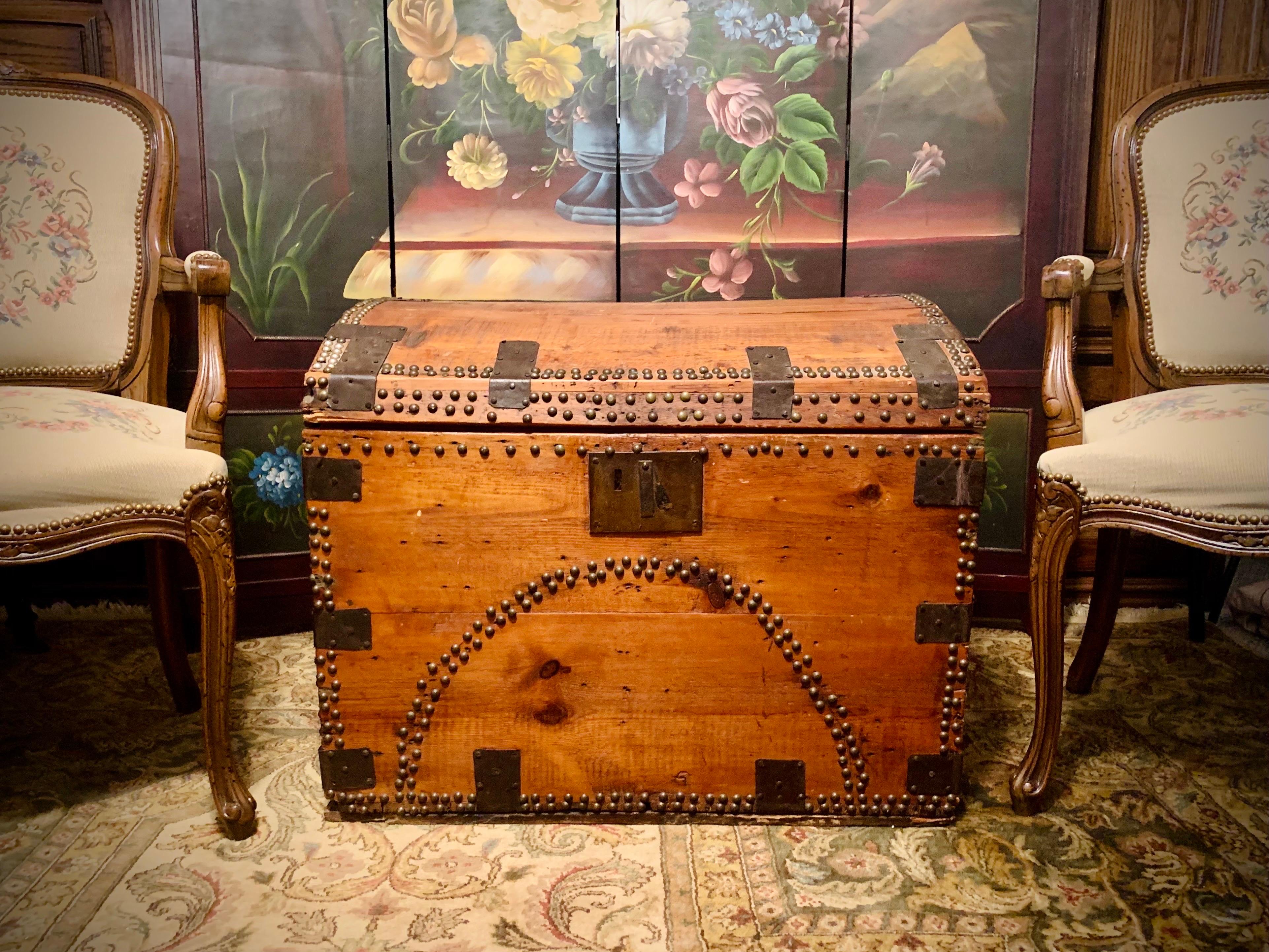 Circa 1860-1870’s this antique wooden chest is a real treasure. Handcrafted of red pine native to the east coast of North America, this piece originates from the time of the American Civil War (1861-1865).  Wrought iron hinges and studded tacks add