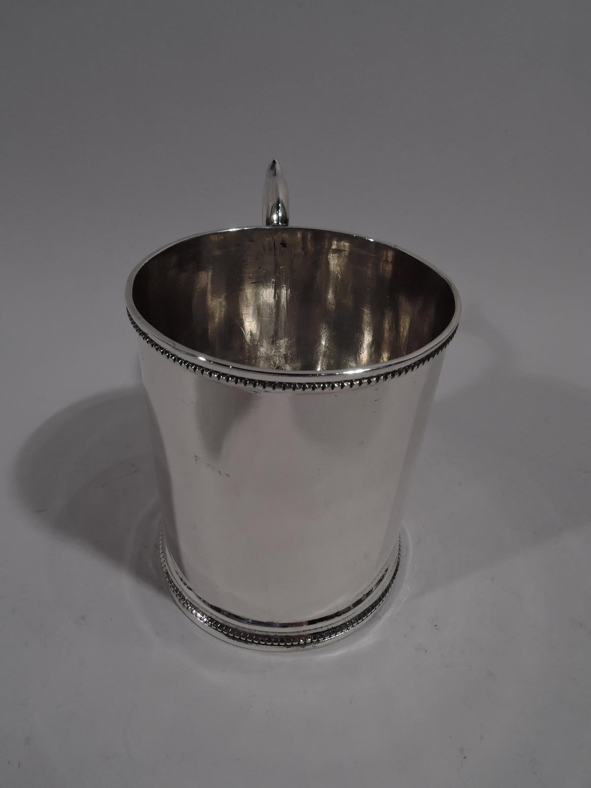 American classical coin silver baby cup, circa 1850. Plain and straight sides with beaded rims and capped S-scroll handle. Lots and lots of room for engraving. Marked underside: “Premium of the / Ills State Agl Society”.

Overall dimensions: H 4 x