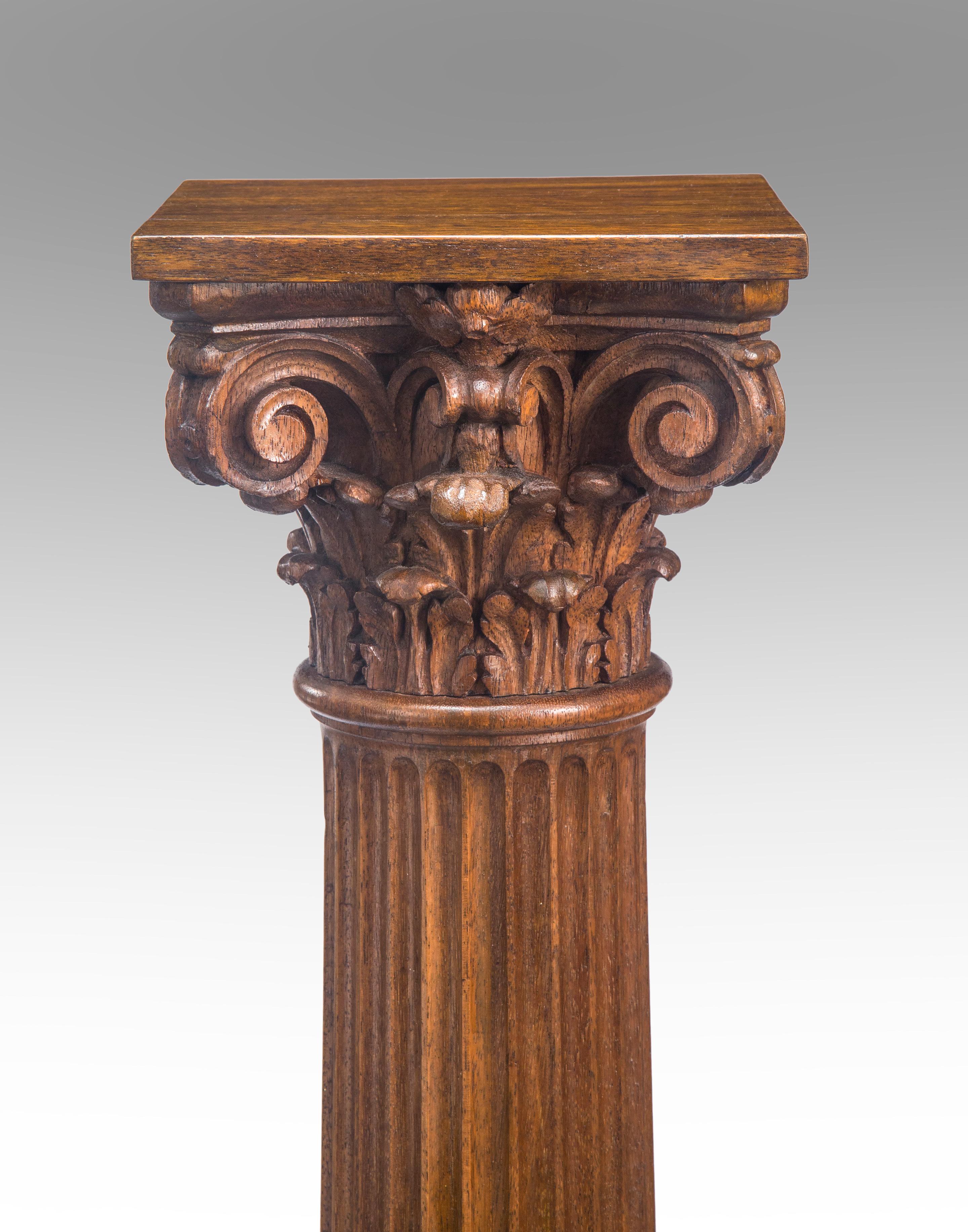 American Classical column oak pedestal
19th century.
Expertly carved column / pedestal of harmonious proportions is an handsome accent piece or a useful pedestal. The carved Corinthian capital below a level display surface, the fluted column above