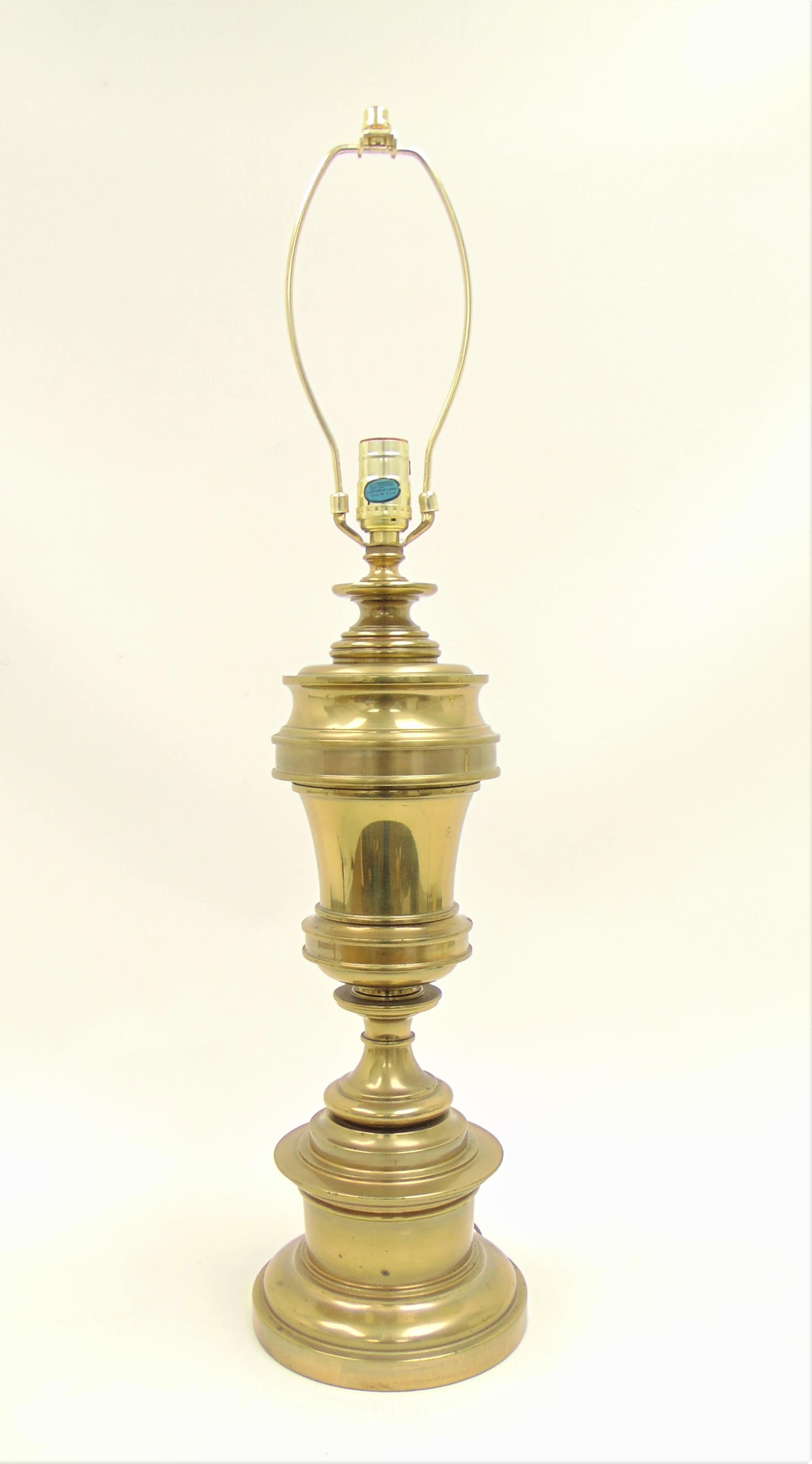 This is a vintage traditional brass Classic lamp by Stiffel. It is of the American Classical style. This lamp is from the 1960s-1970s. It turns on and off at the back of the lamp near the base where the turn is located. It is very elegant and