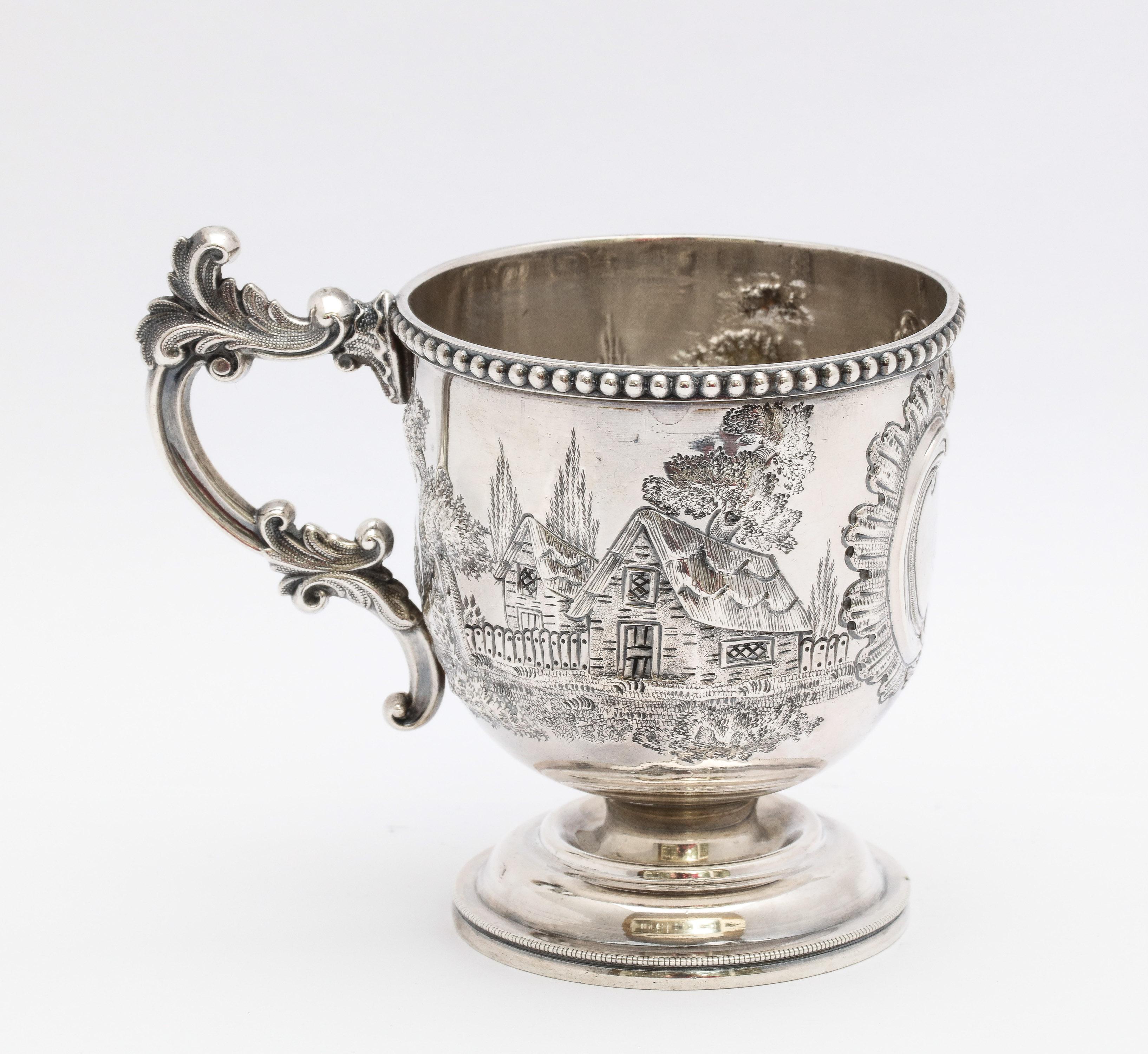 American Coin Silver (.900) cup/mug on pedestal base, Bailey and Company, Philadelphia, circa 1846-1878. Decorated with country cabins in the woods. Bead work decorates the upper rim of the mug. Inscription in the cartouche reads - Little Mary.