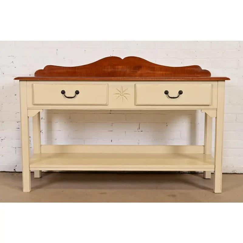 A gorgeous Early American, Colonial, or French Country style sideboard, buffet server, sofa table, or console table

USA, Late 20th Century

Carved maple, with cream lacquered base, and original brass hardware.

Measures: 54