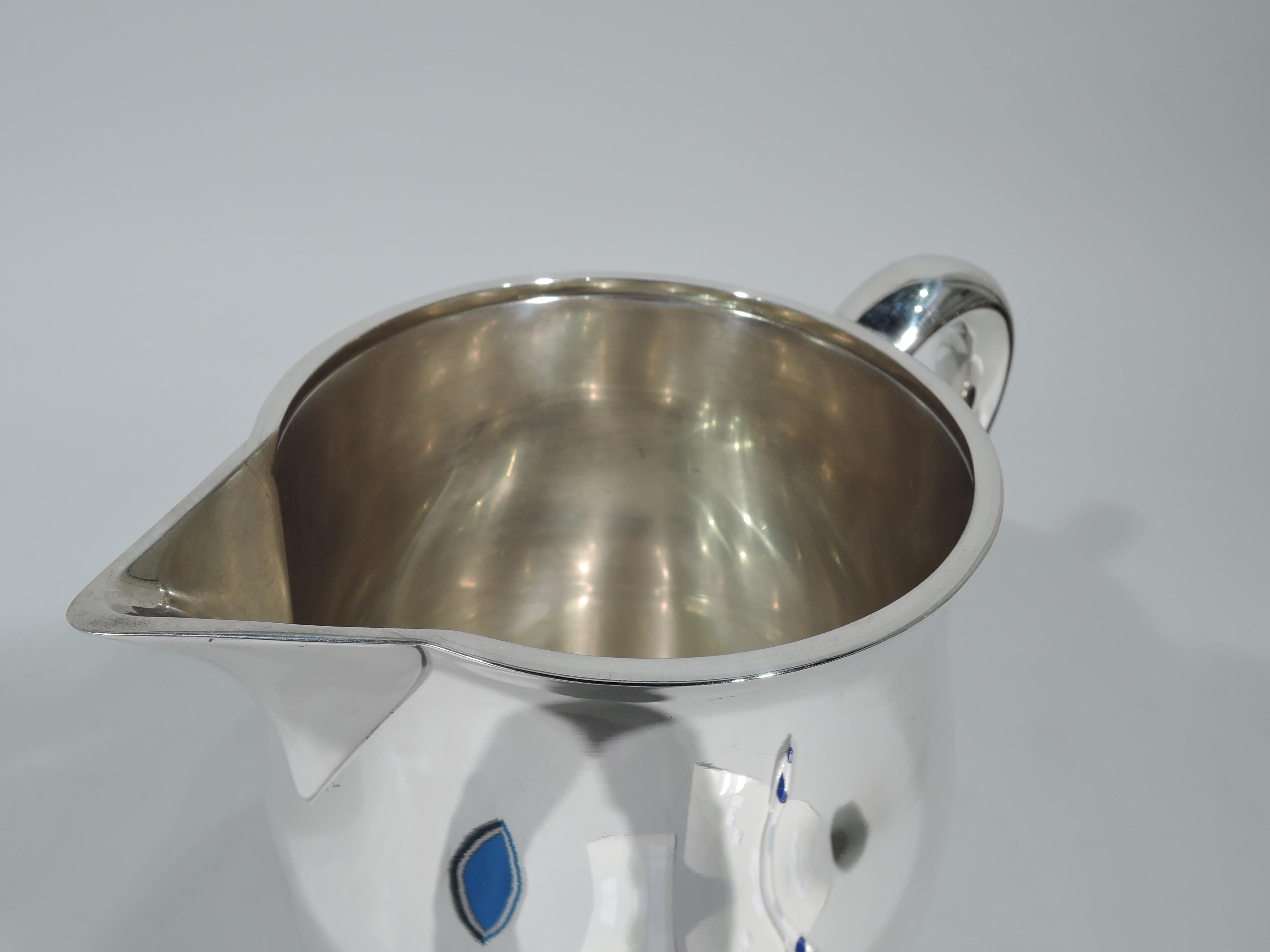 Colonial Revival sterling silver water pitcher. Made by Tuttle in Boston in 1953. Gently curved body, c-scroll handle, and sharp v spout. A beautiful design by Paul Revere that also works on Modern tables. Fully marked including maker’s stamp,