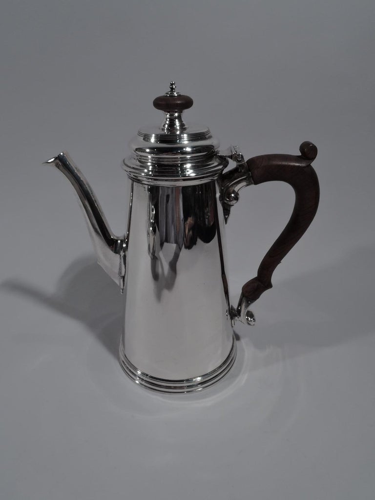 American Colonial Revival sterling silver 3-piece coffee set. Retailed by Georg Jensen USA in New York, circa 1950. This set comprises coffeepot, creamer, and sugar. Coffeepot: Truncated cone body, molded and double-domed hinged cover with