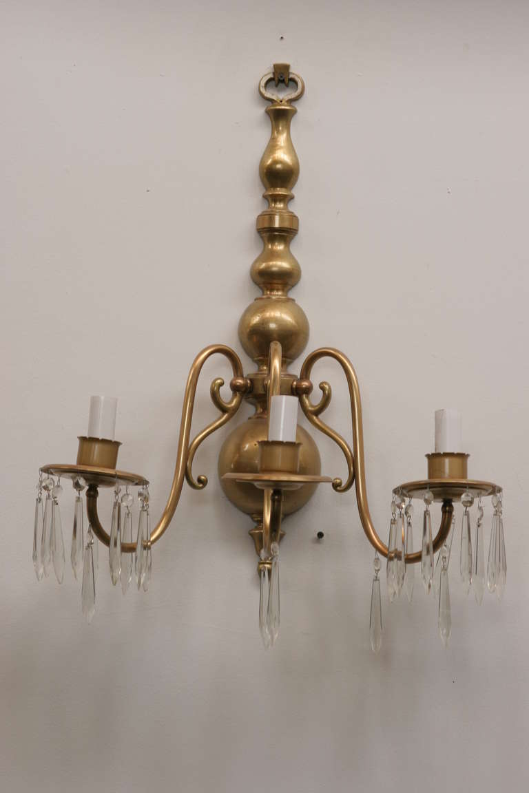 American Colonial style solid brass wall sconce with 3-tier candleholders converted into electric.

Available-7.