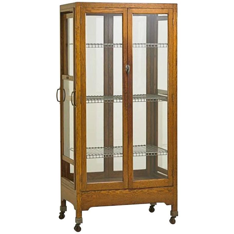 Oak with glass doors (on two sides) and sliding side sections, metal adjustable racks, metal casters, circa 1900. Three (new) glass shelves also included. 

Once used as a commercial grade pie safe, this item can be used as intended in the kitchen