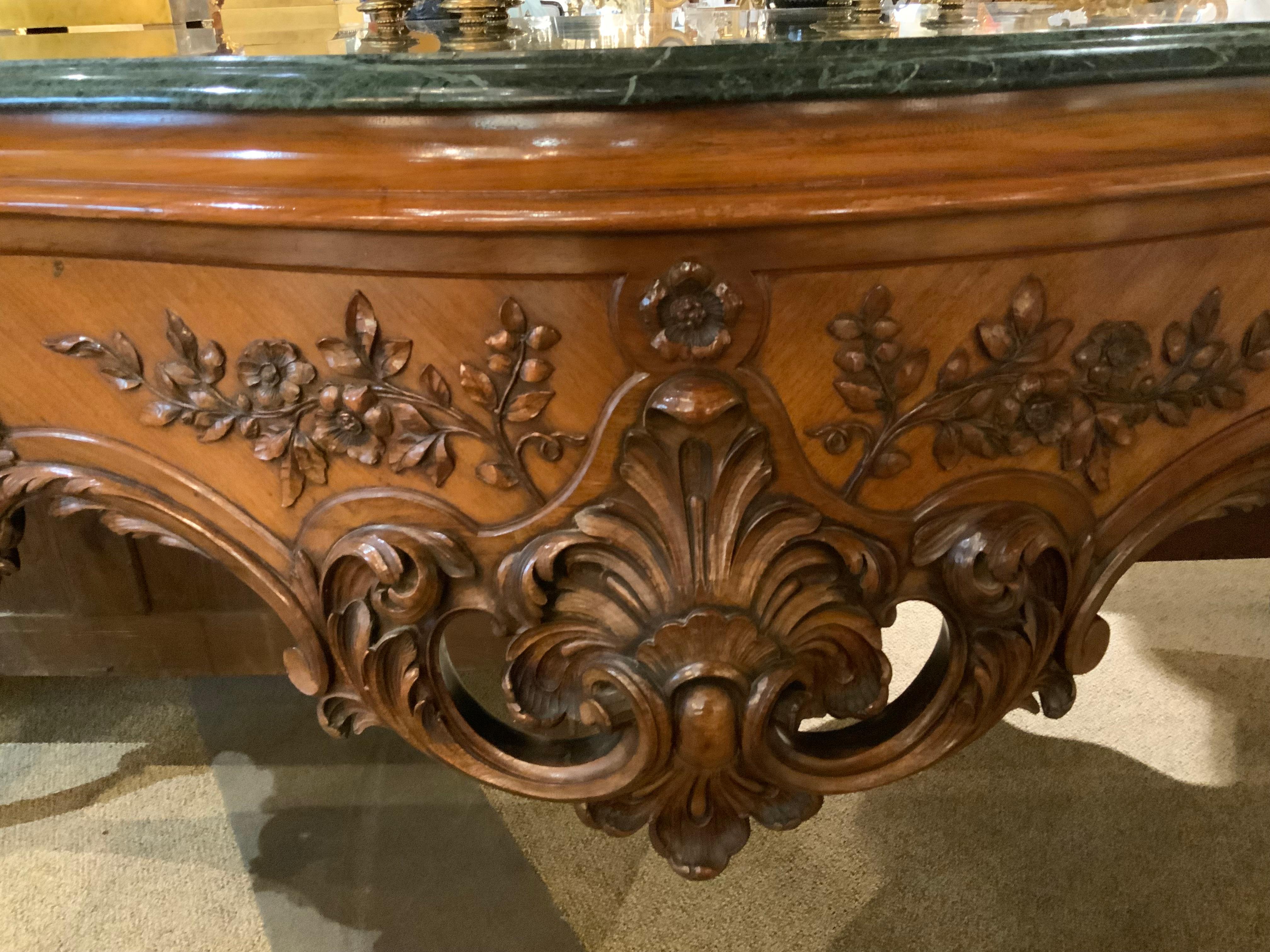 The quality of the rosewood and the carving utilized
In this exceptional piece of furniture is special. It has
A deep green hue in the marble top, the sides have a
Graceful curve and the legs are also curved in the Louis XVI
Fashion. The center