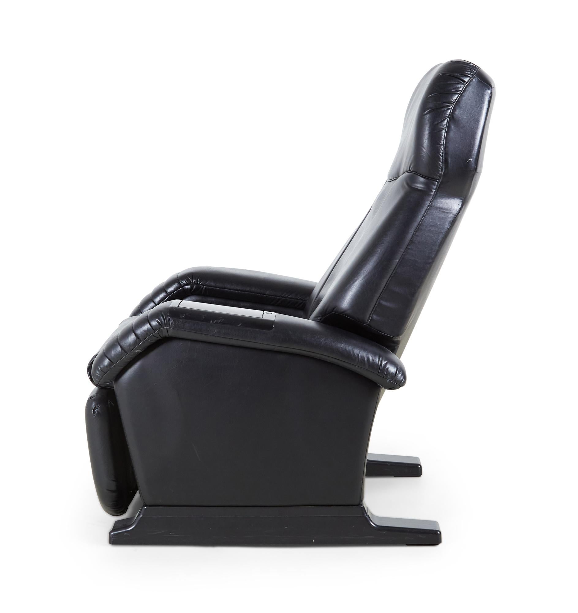 American contemporary black leather massage recliner armchair with control panel in the padded armrest and cassette player (GET-A-WAY Model GS-01, working).
  